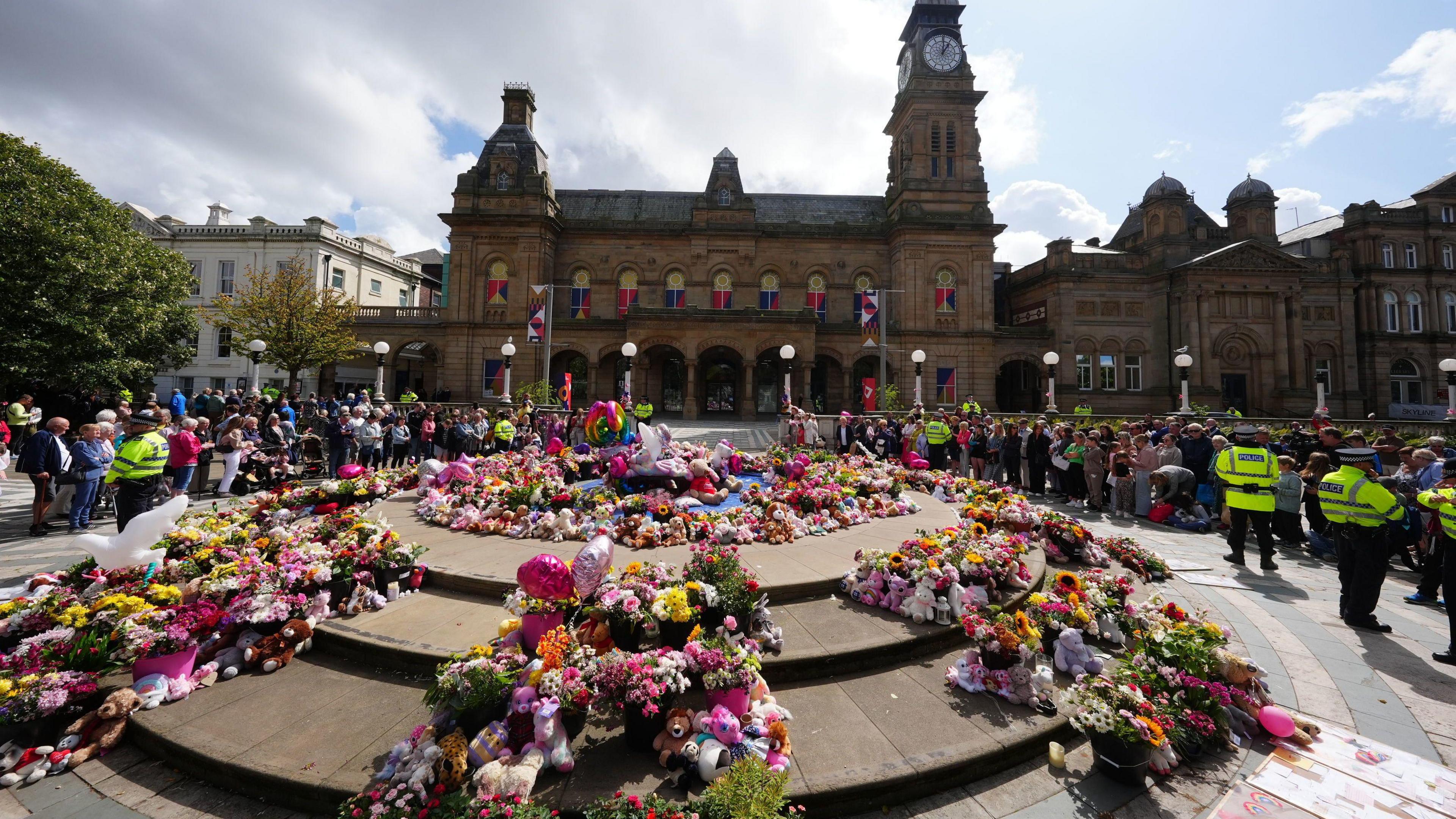 Floral tributes laid outside The Atkinson in Southport town centre