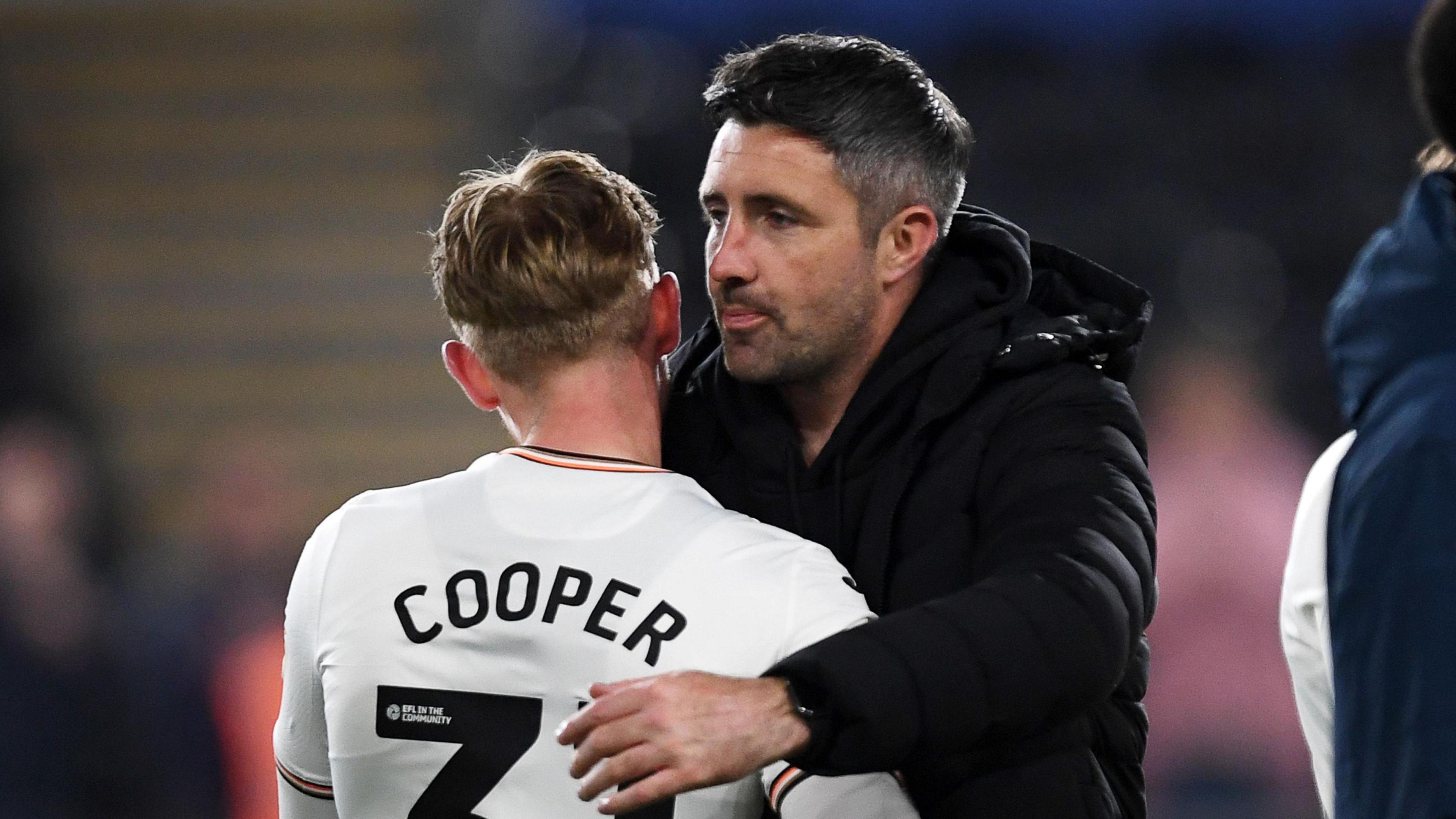 Ollie Cooper embraces Alan Sheehan last season