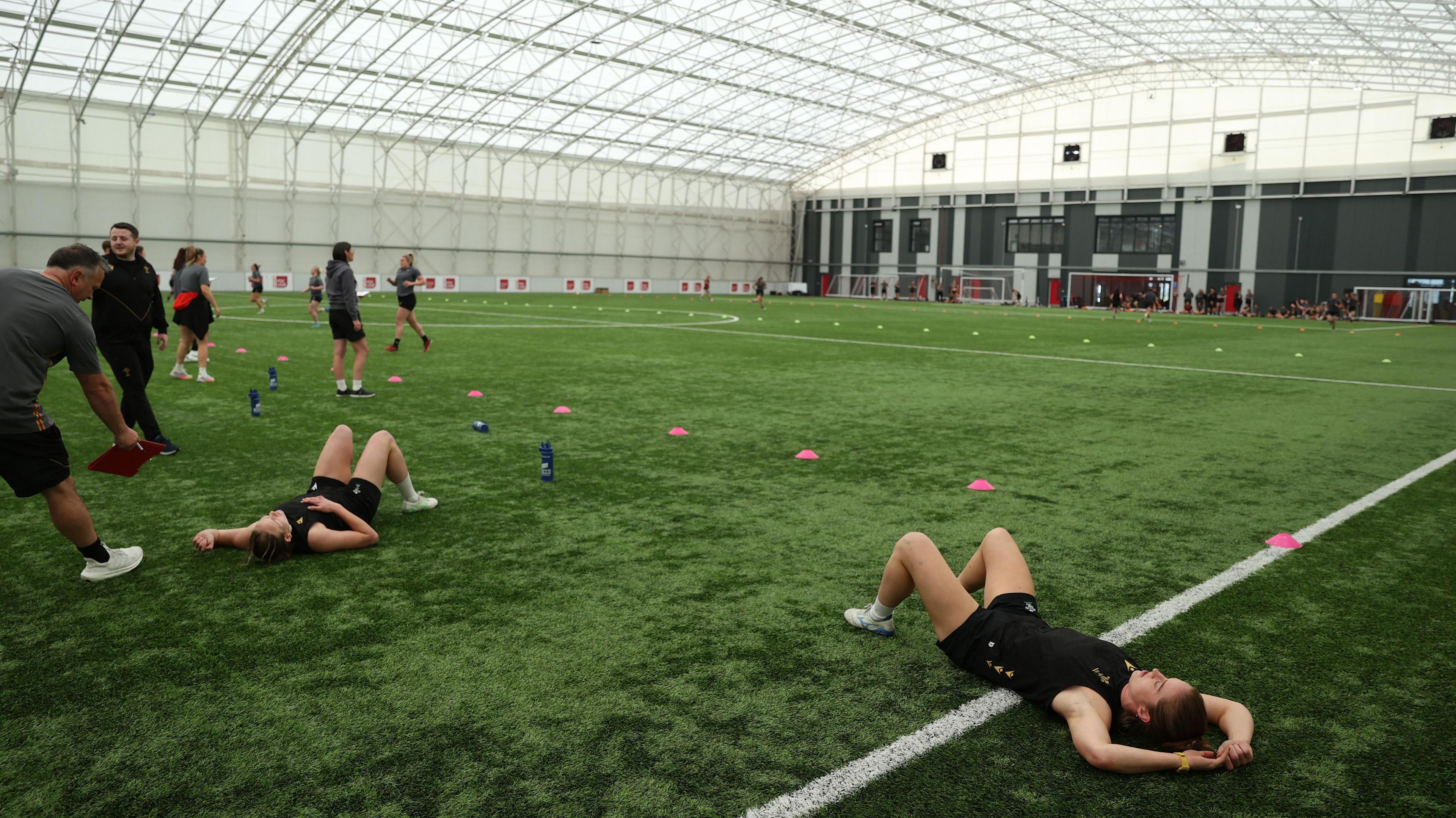 Carys Cox and Lisa Neumann collapsed on the turf after pre-season testing