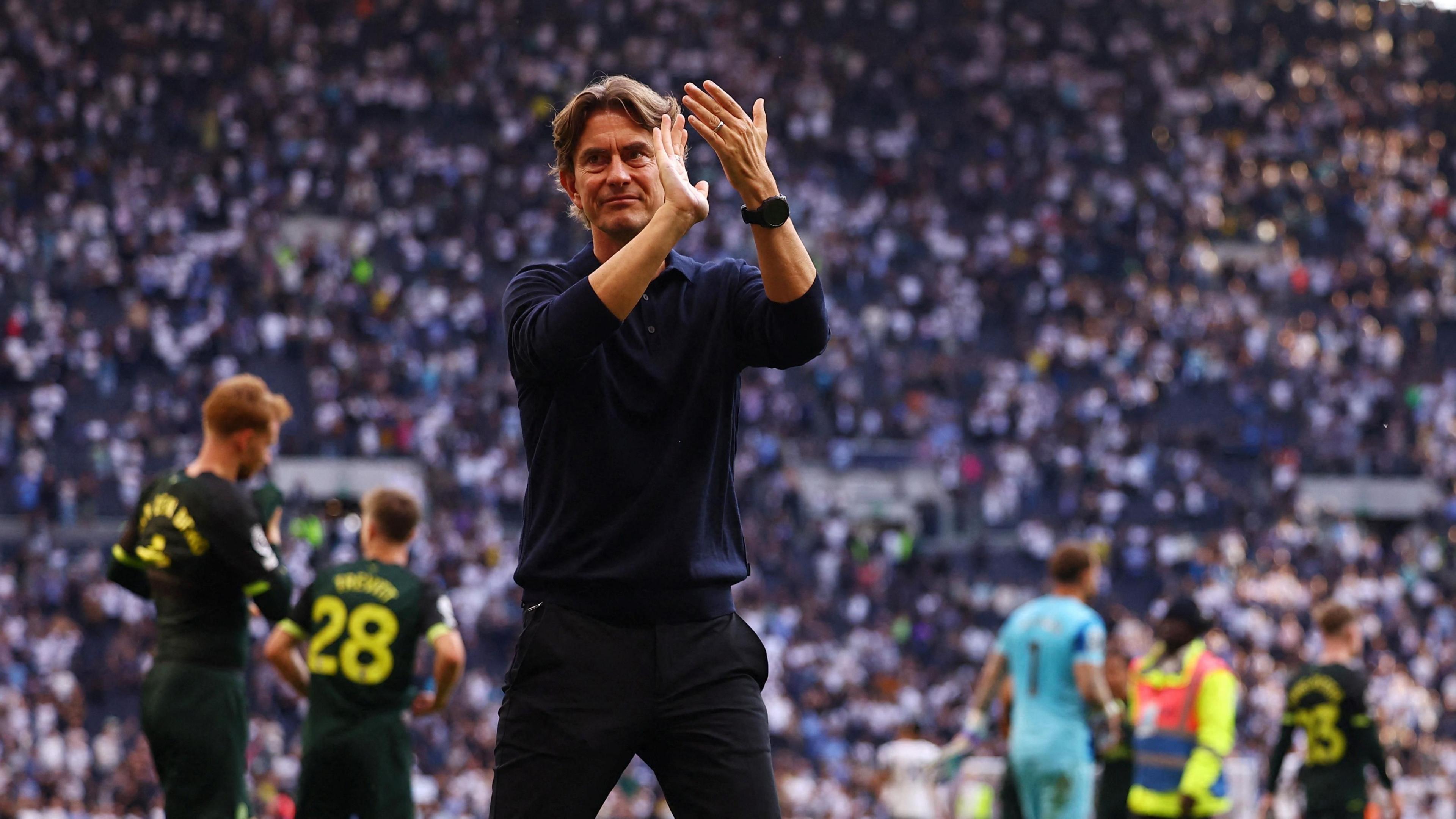 Thomas Frank applauds Brentford fans at the Tottenham Hotspur stadium