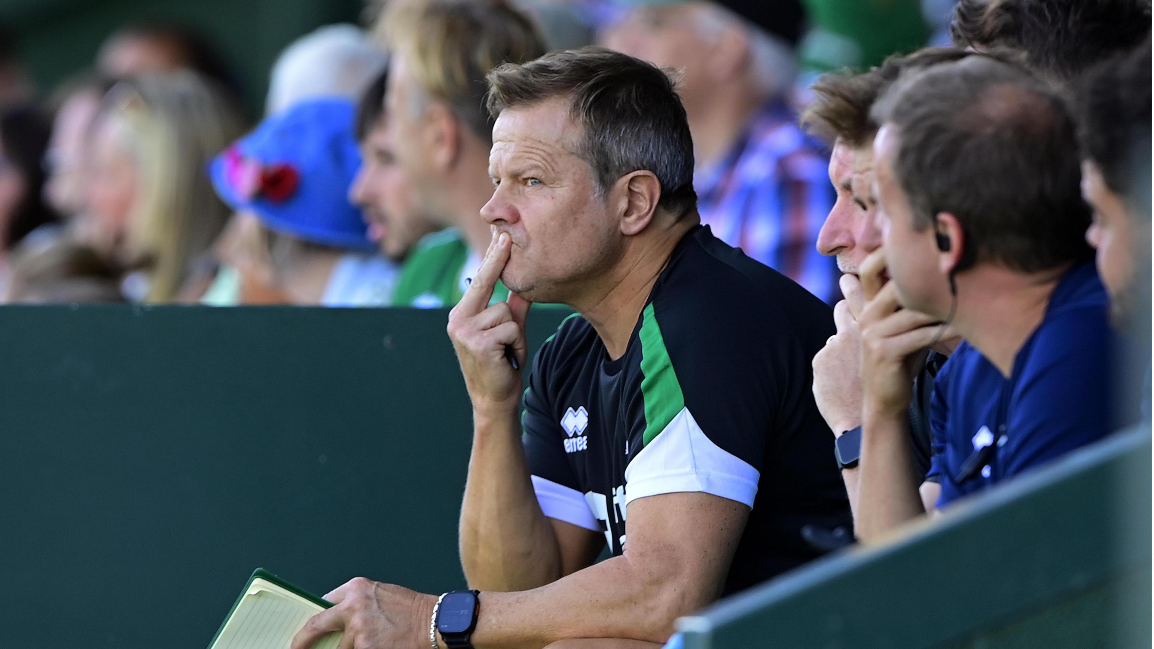 Mark Cooper sits in the Yeovil dugout with his hand resting on his mouth
