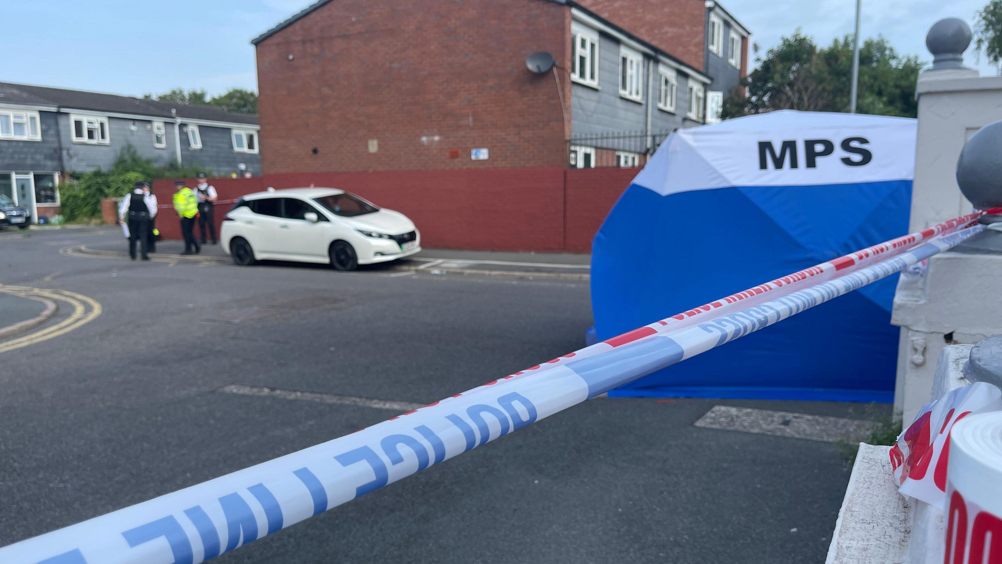 A blue police tent at the scene