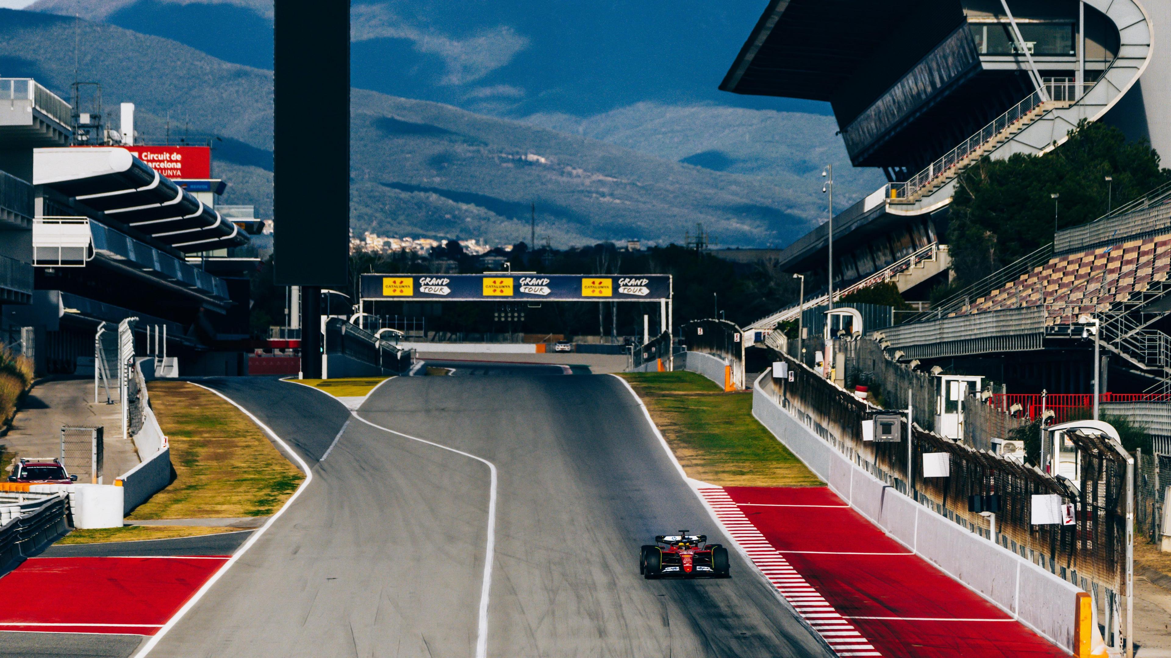 Lewis Hamilton heads down the pit straight with the Pyrenees in the background