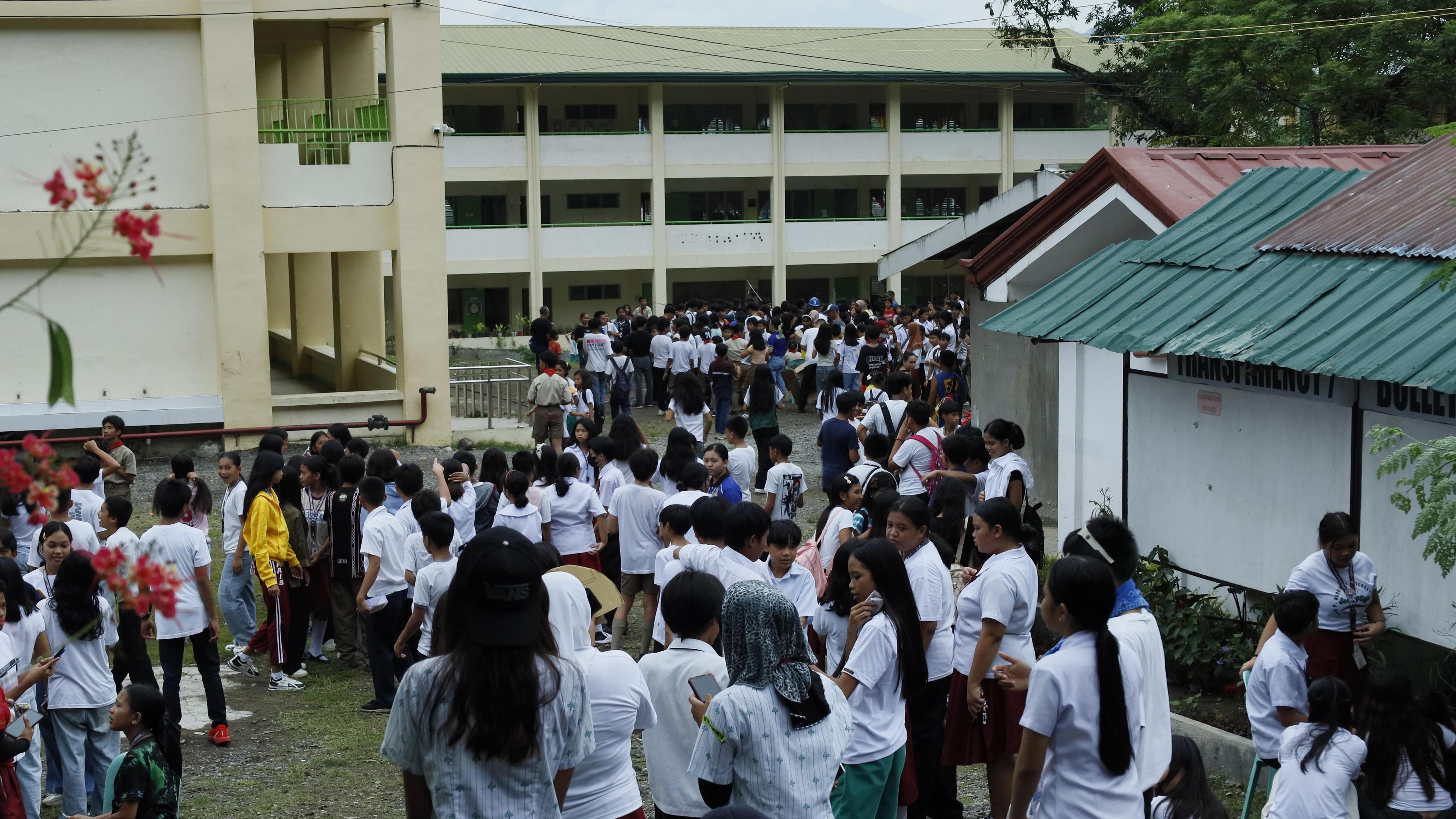 Students rush to safe ground following an earthquake, at a school in Davao city, Philippines, 10 October 2025. 
