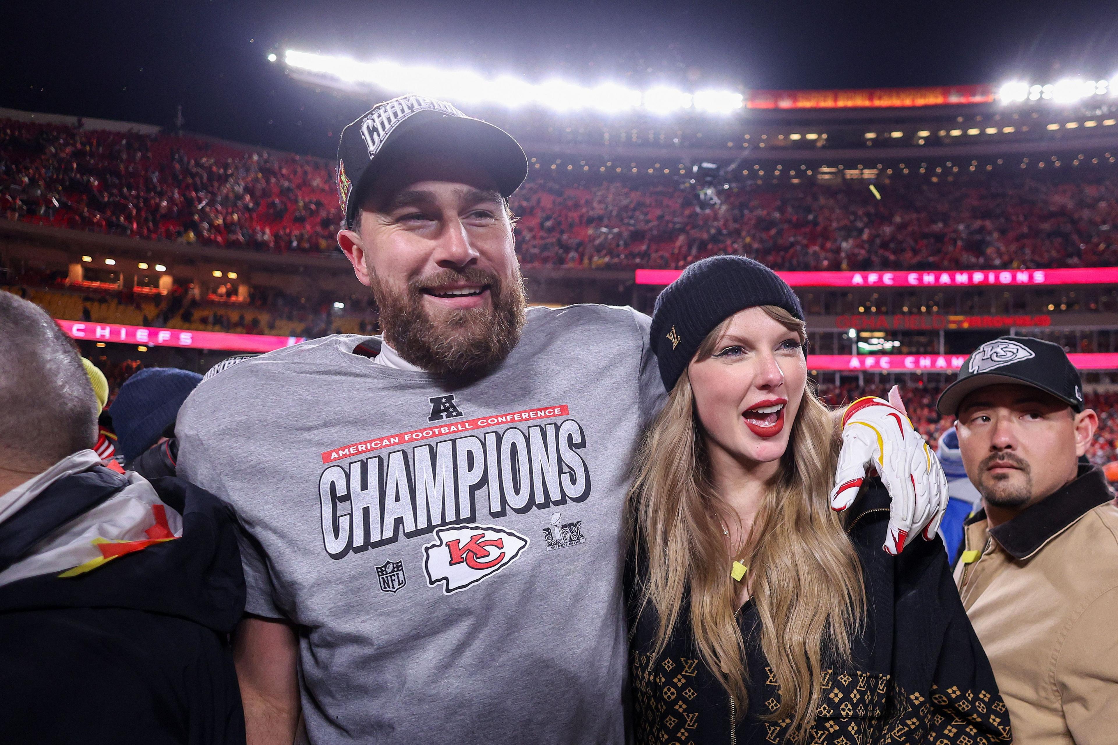 Taylor Swift celebrates with Travis Kelce of the Kansas City Chiefs after defeating the Buffalo Bills 32-29 in the AFC Championship Game at GEHA Field at Arrowhead Stadium 