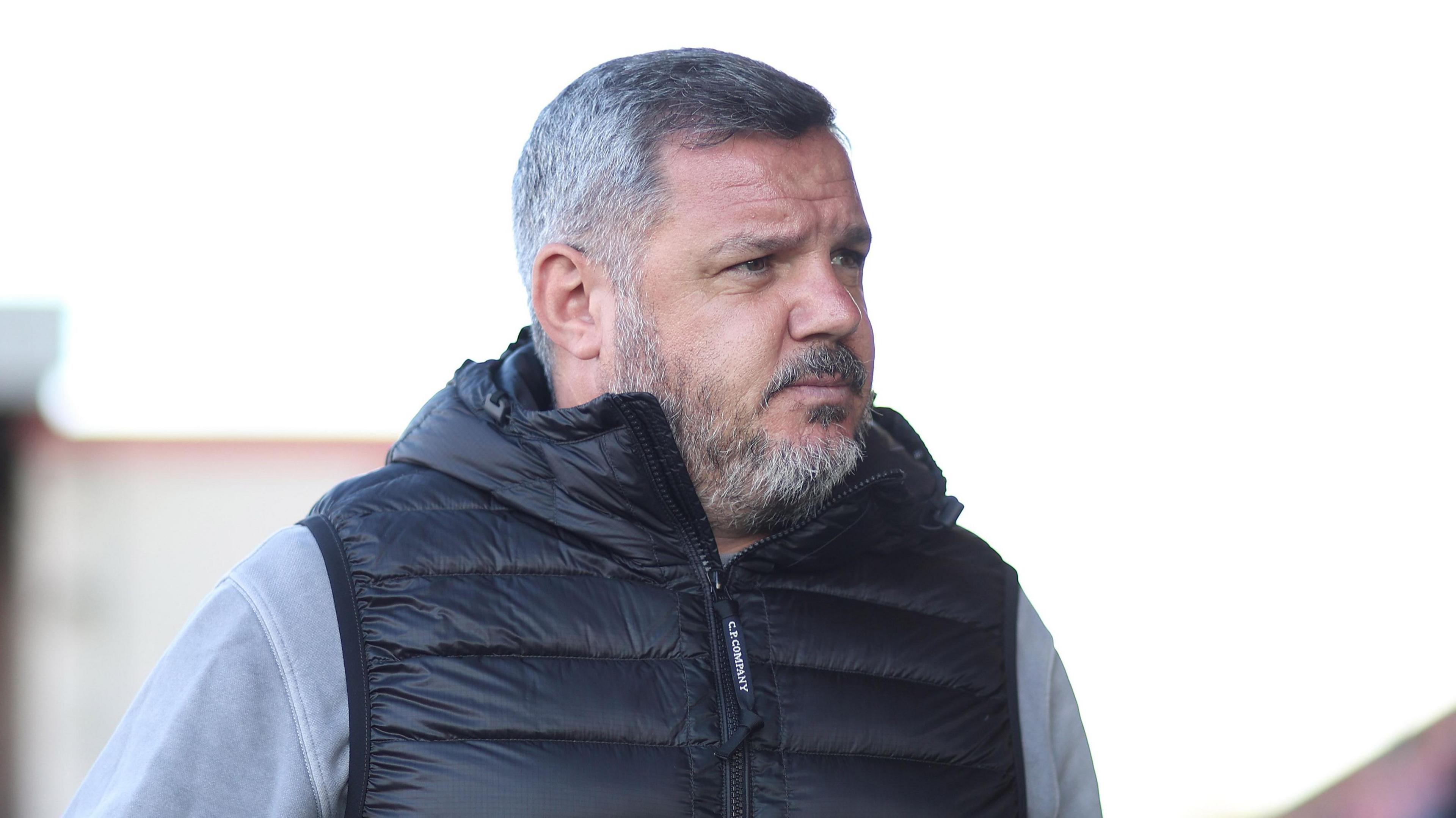 Dean Brennan walking inside a ground before a match
