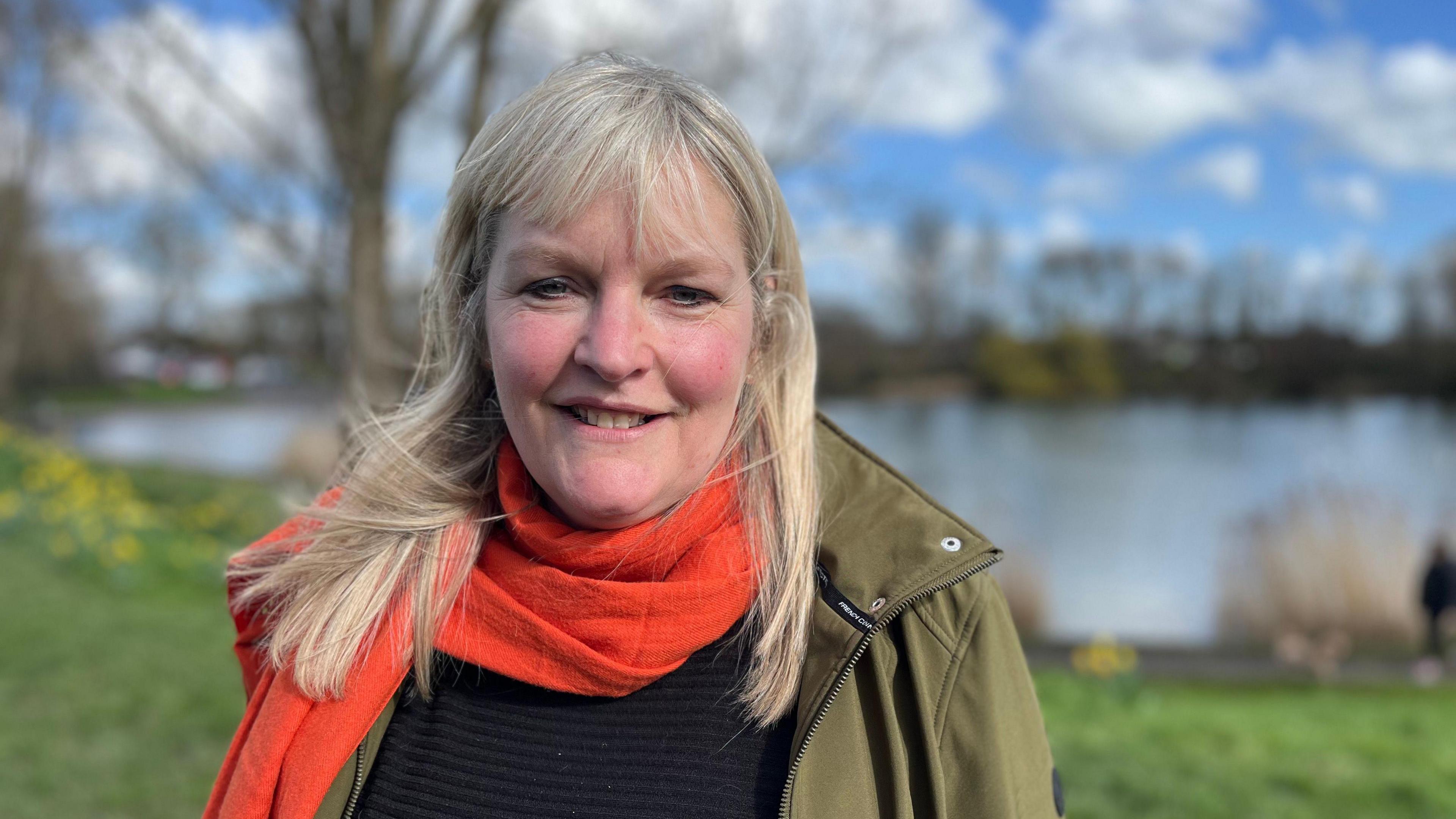 Claire Sully standing in front of a lake