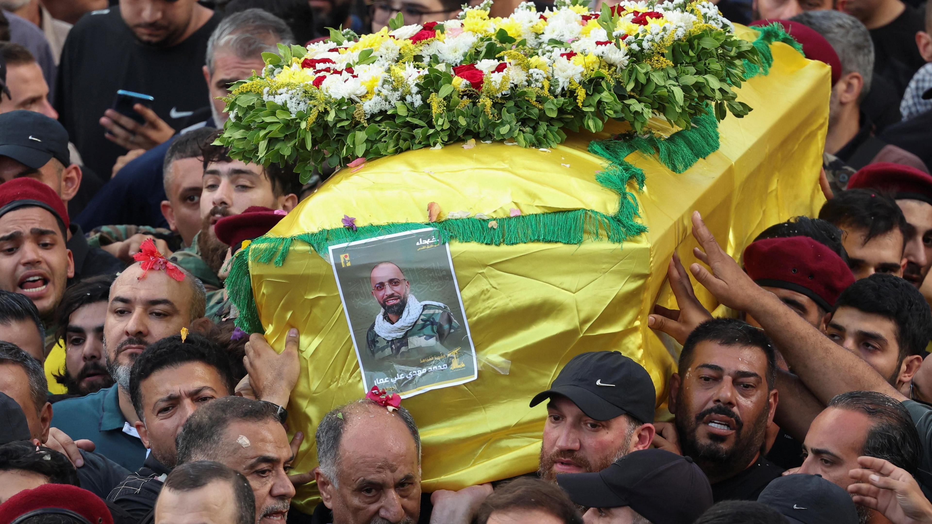 Mourners carry the coffin of Hezbollah fighter Mohammed Ammar, son of Hezbollah MP Ali Ammar, during his funeral in Beirut, Lebanon (18 September 2024)