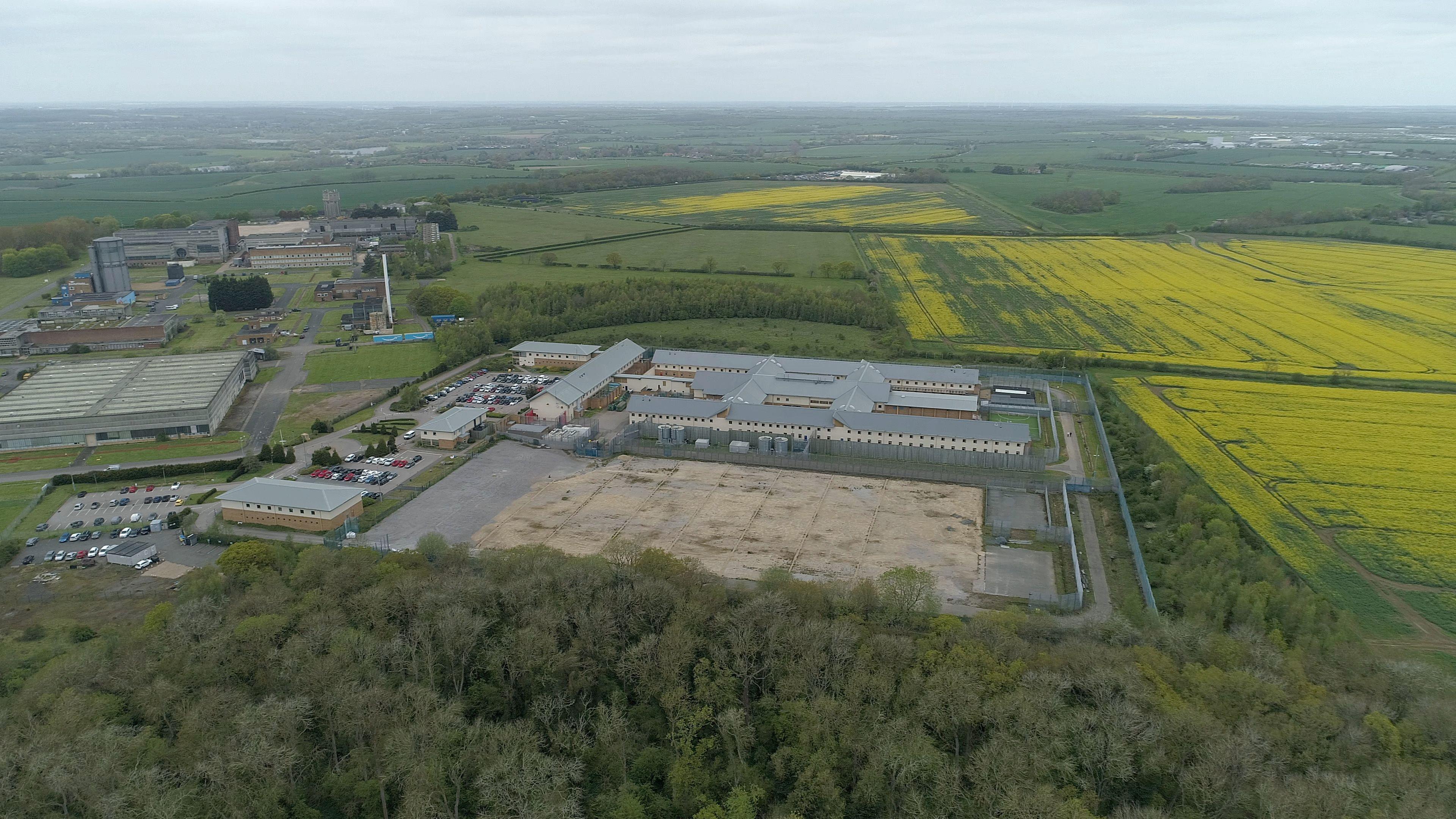 A drone image of Yarl's Wood. It shows the entire centre from above. Several buildings can be seen as well as a large open area. Fields surround the centre.