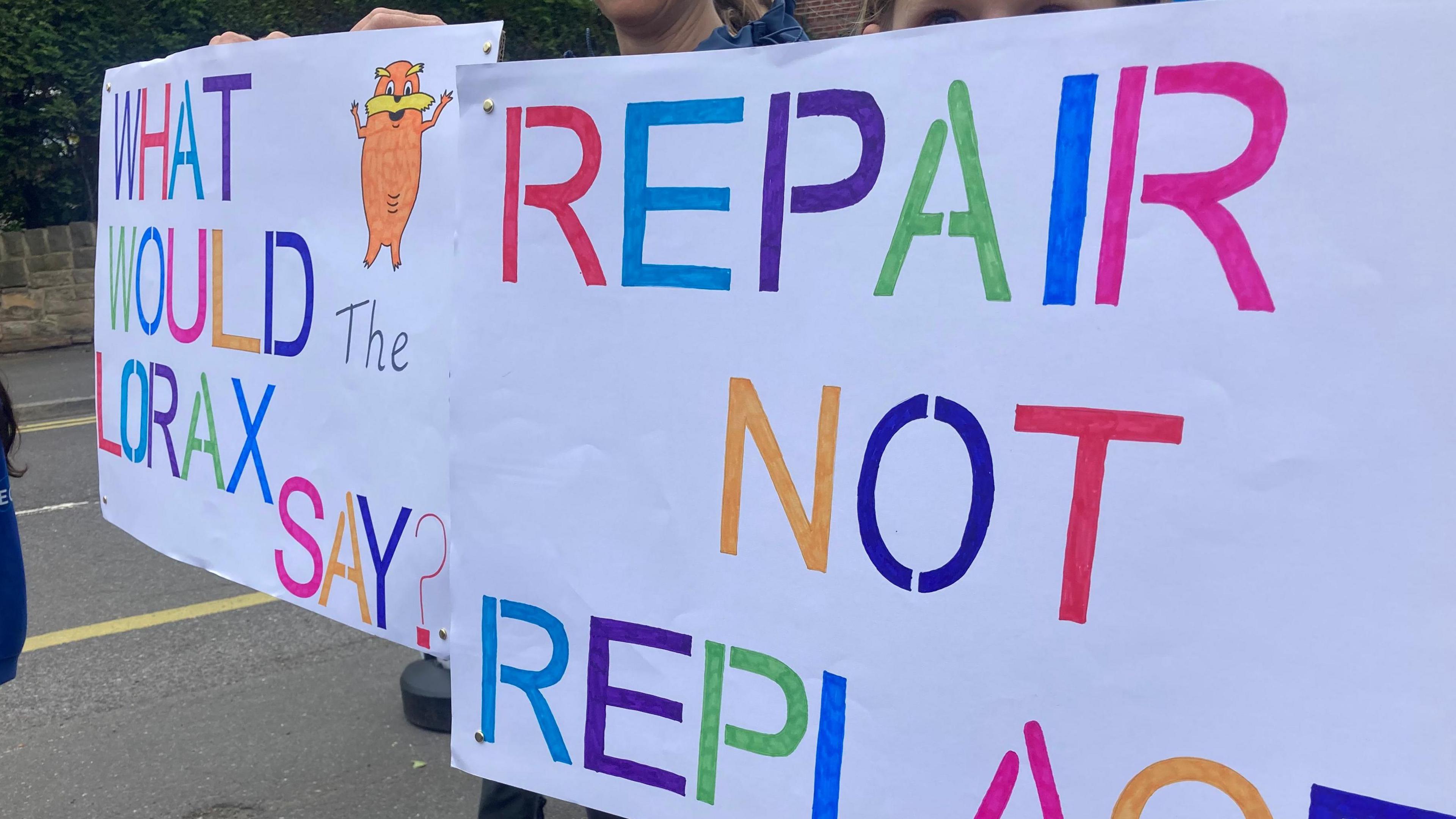 Protesters holding placards