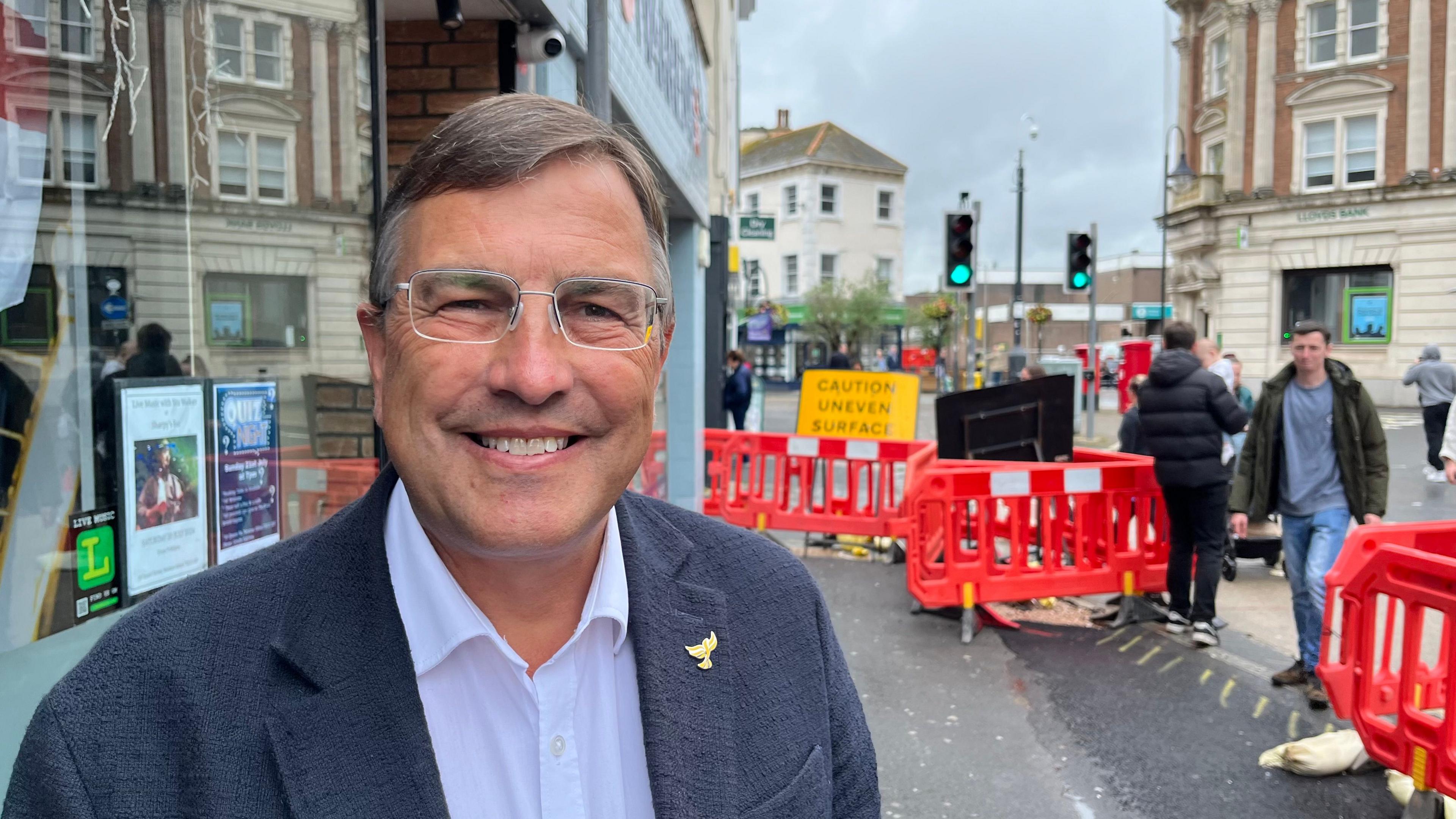 Martin Wrigley standing in front of works in Queen Street