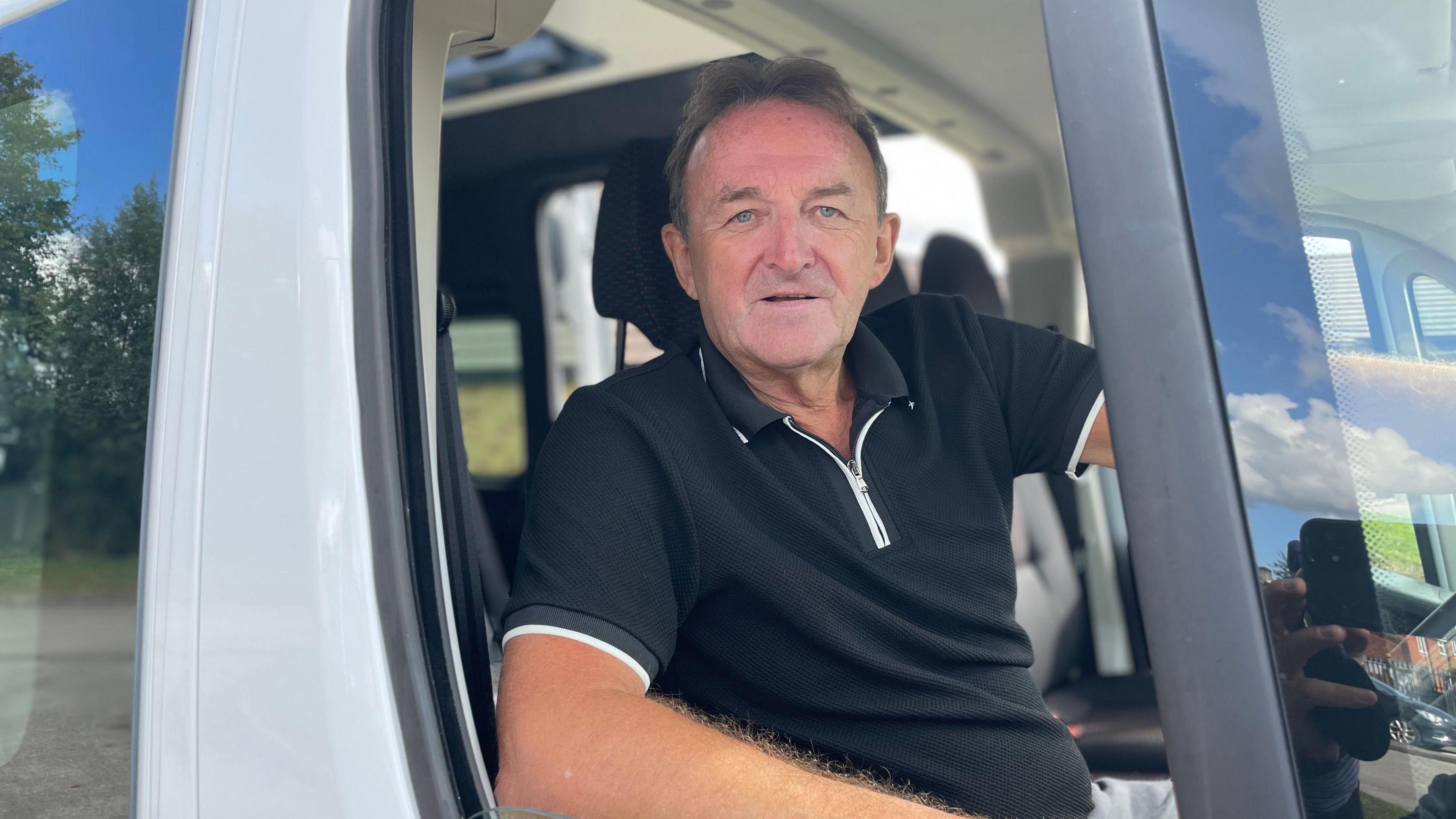 Steve Wright in the driving seat of a minibus