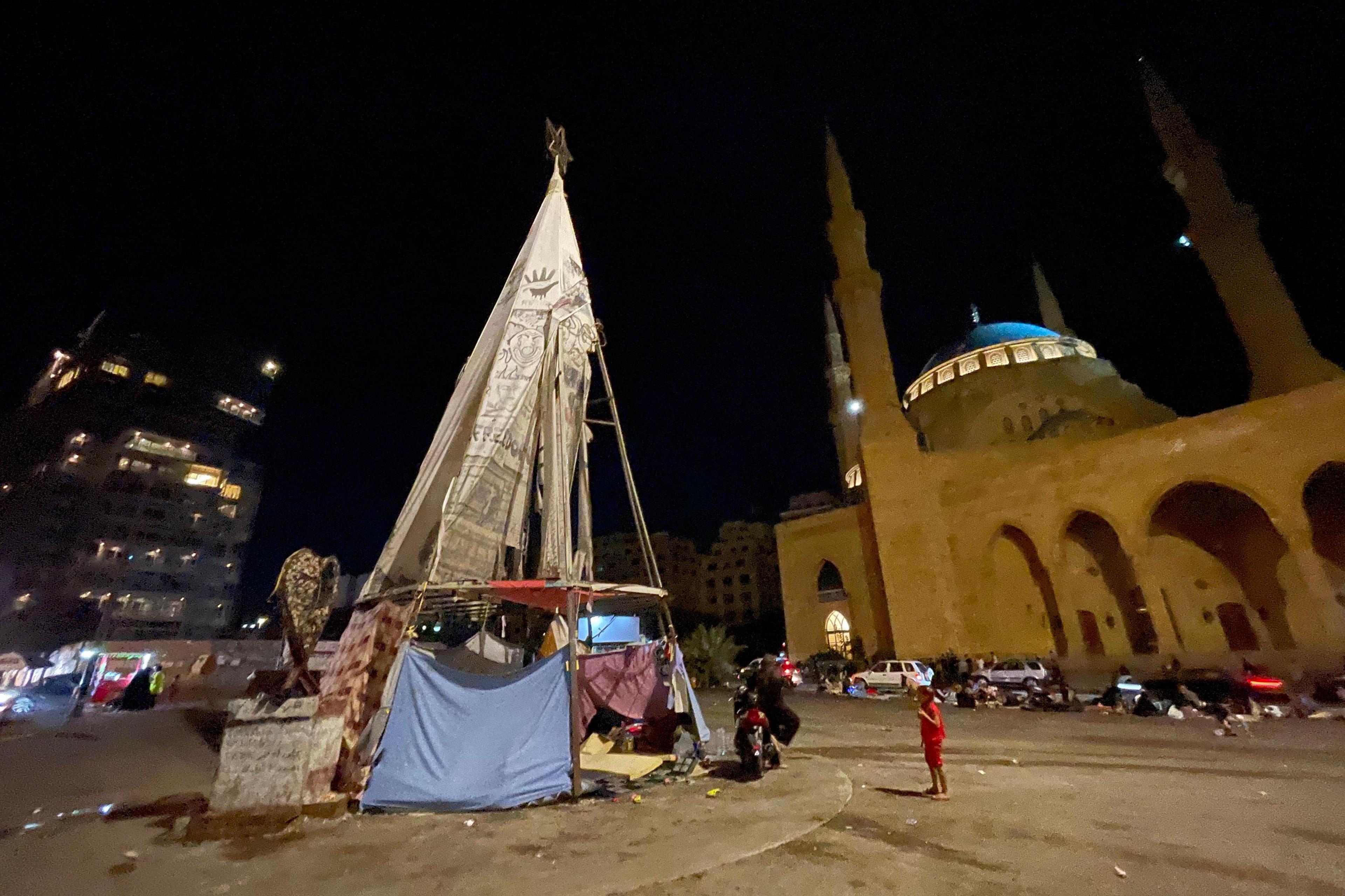 People who've fled there homes are everywhere in Beirut - including under this skeleton of a Christmas tree in Martyrs' Square