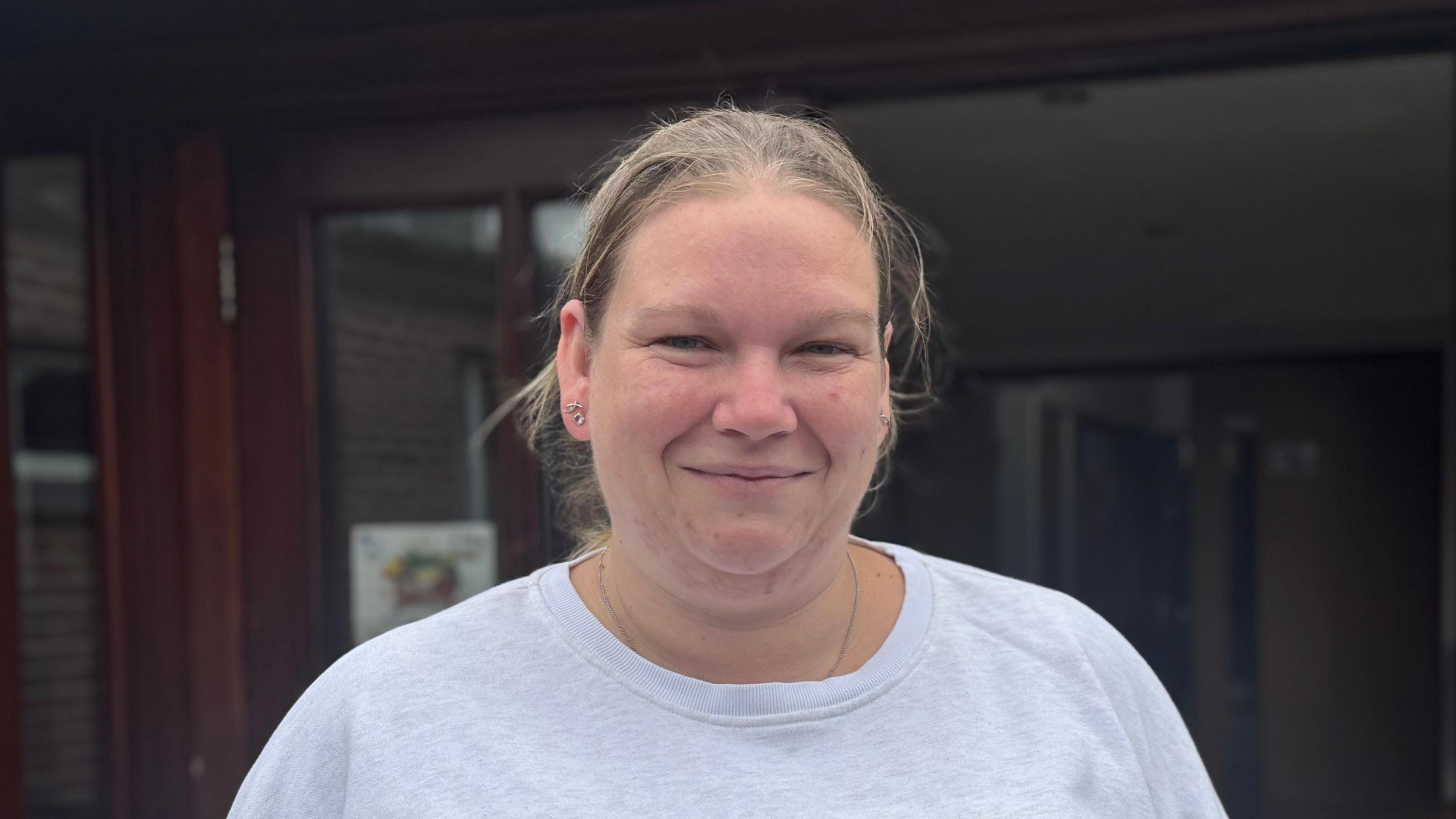 A head and shoulders picture of Natalie Hull. She is wearing a light grey top and smiling into the camera.