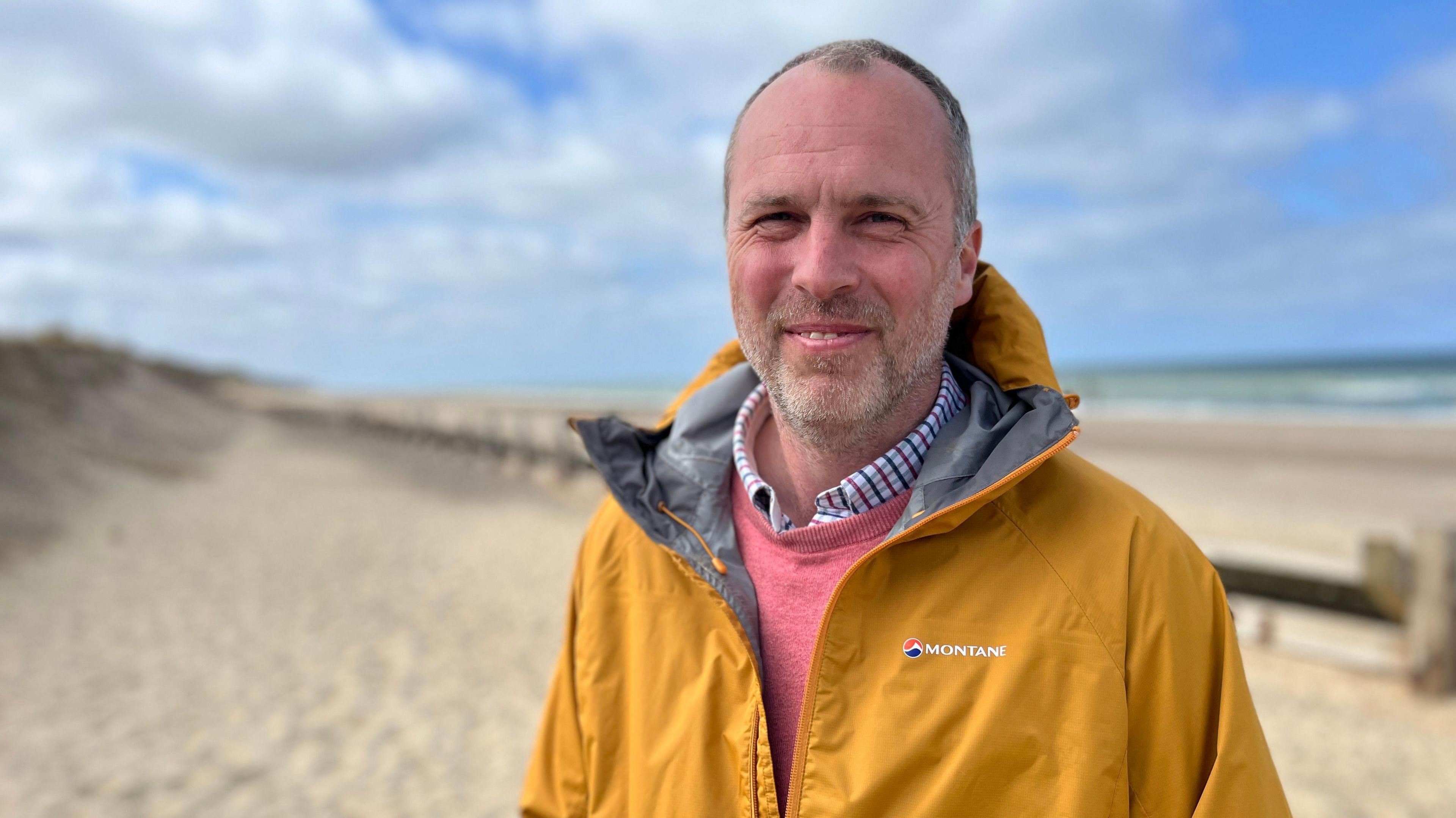 Rob Goodliffe standing on the beach below Bacton gas terminal