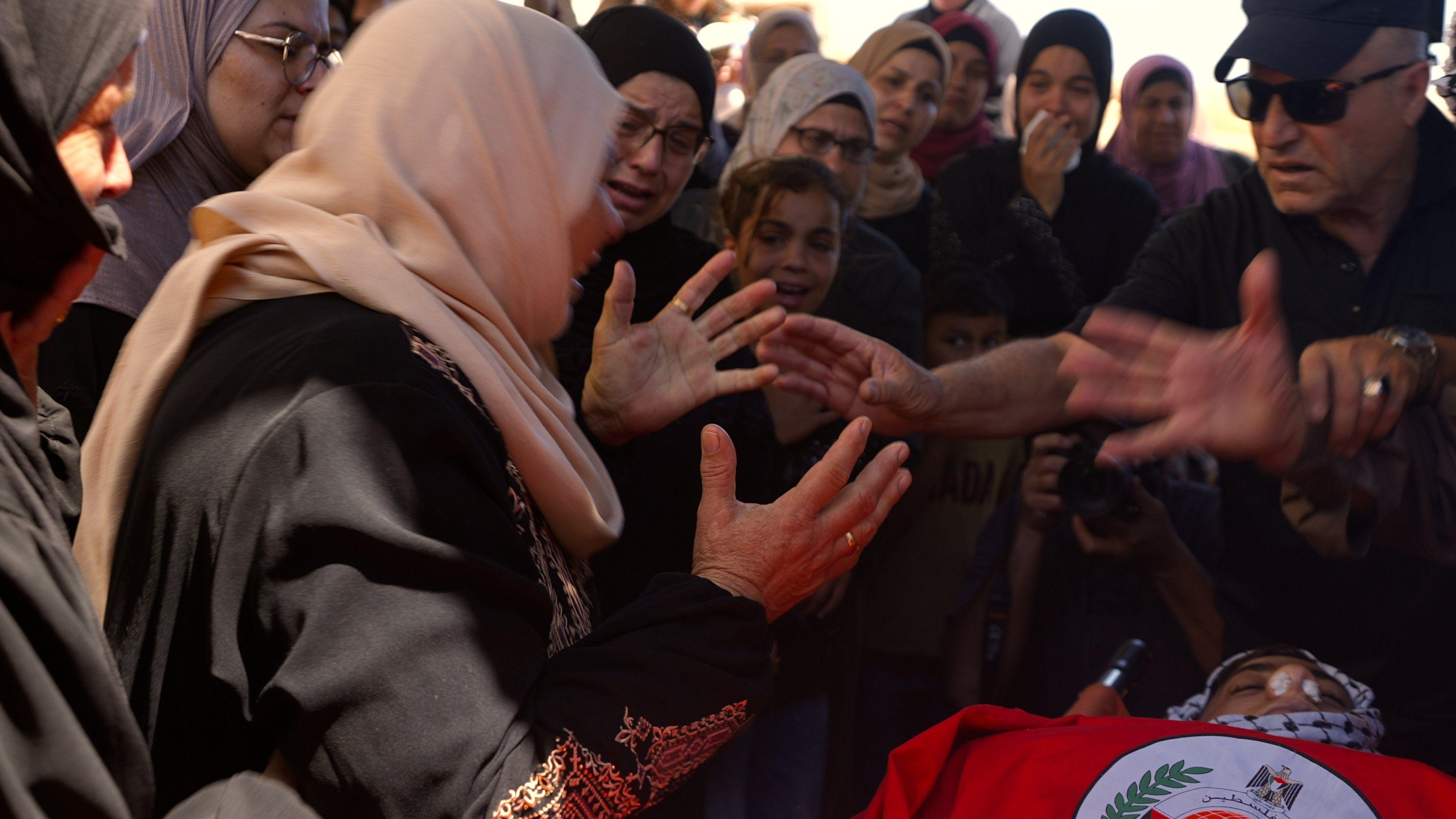 Mother of 18-year-old Hamdan Abu-Elaya cries at his funeral, after he was shot and killed by Israel troops