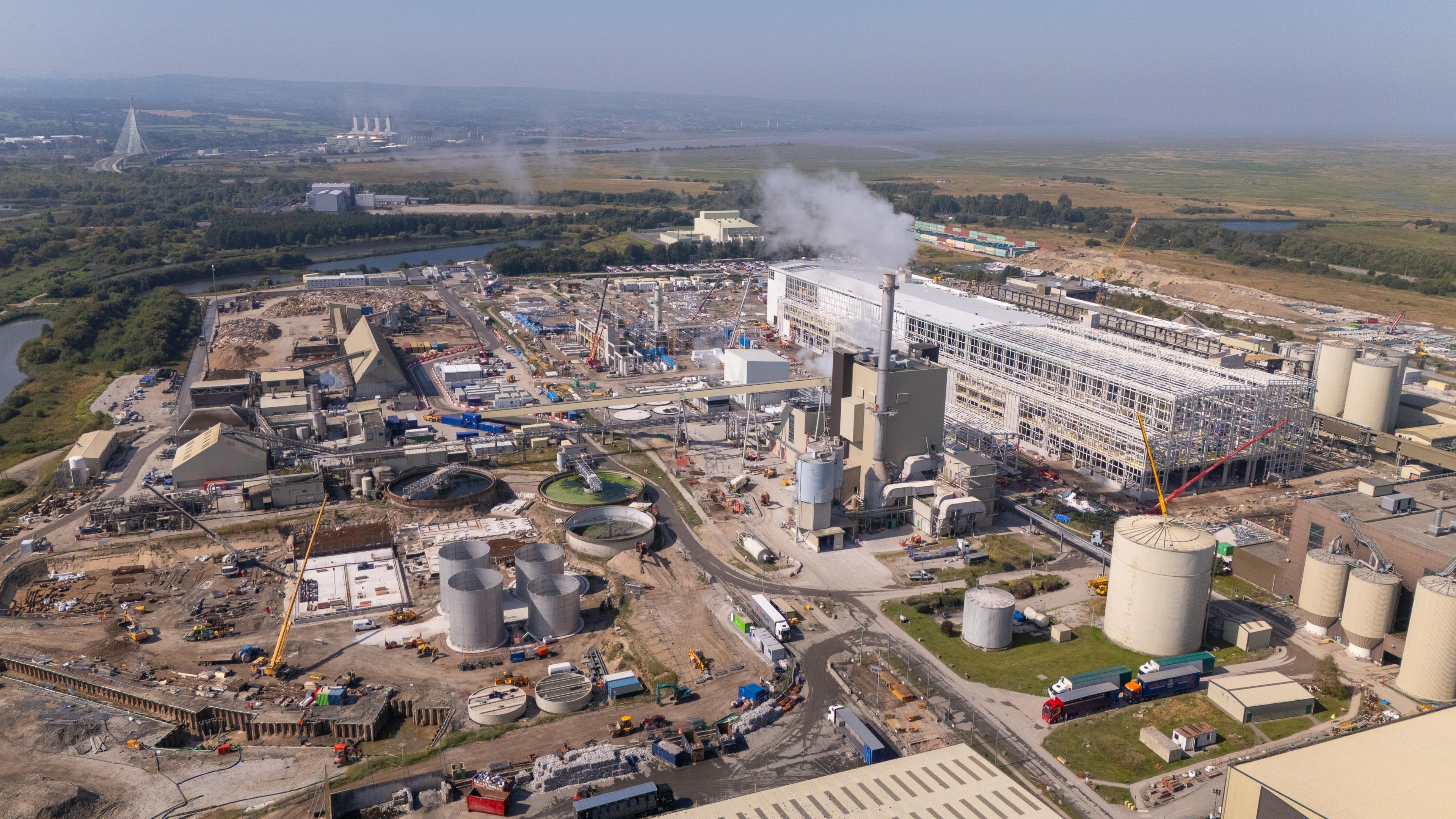 Industrial estate, there is a building on the right and much construction work happening in the left and foreground of the photo