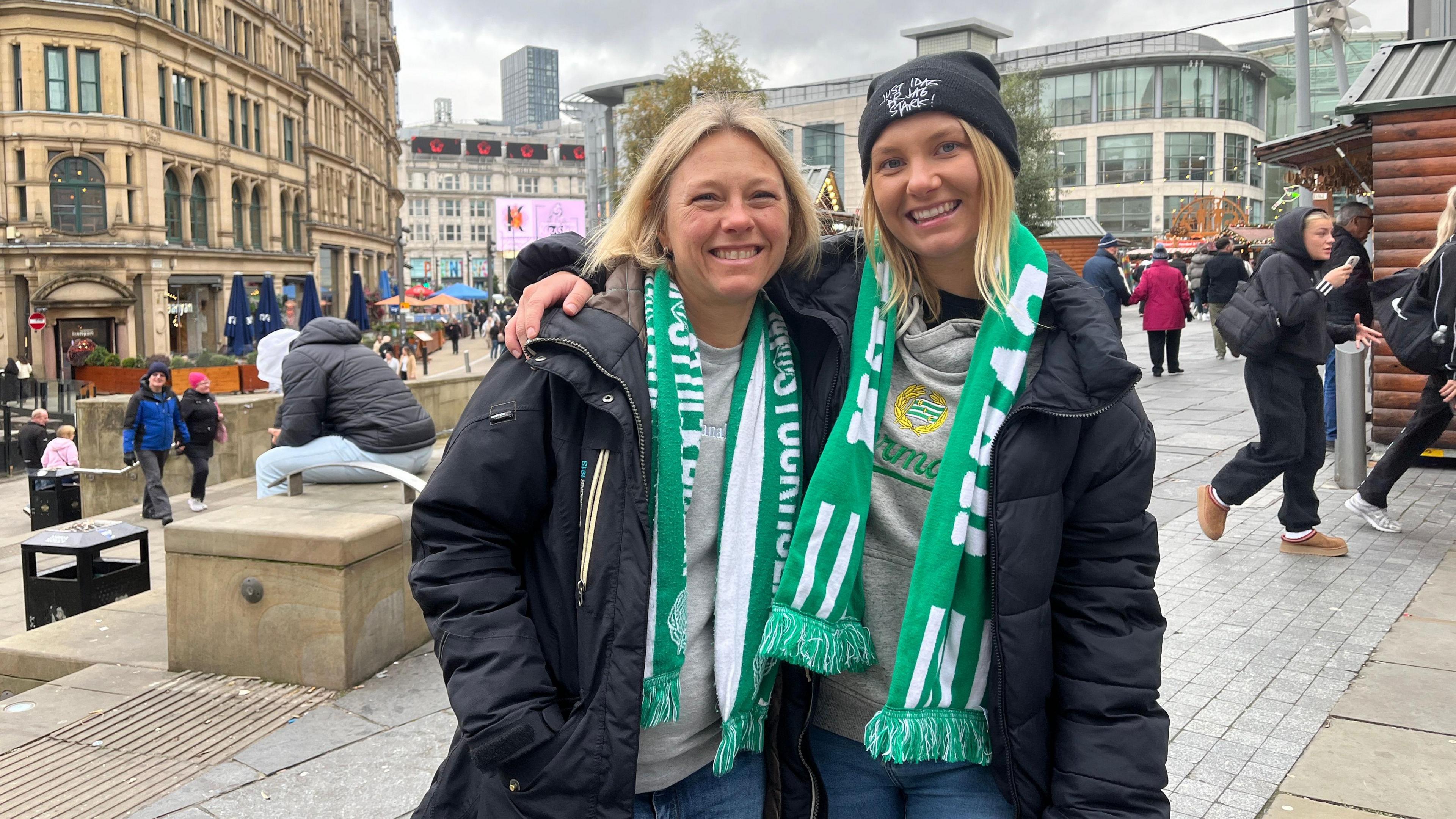 Alexandra Nyreröd poses with her mother with her Anna Persson. They have both come to Manchester to see their team Hammarby take on Manchester City in the Women's Champions League. Both are smiling as they sport their team's green and white colours.