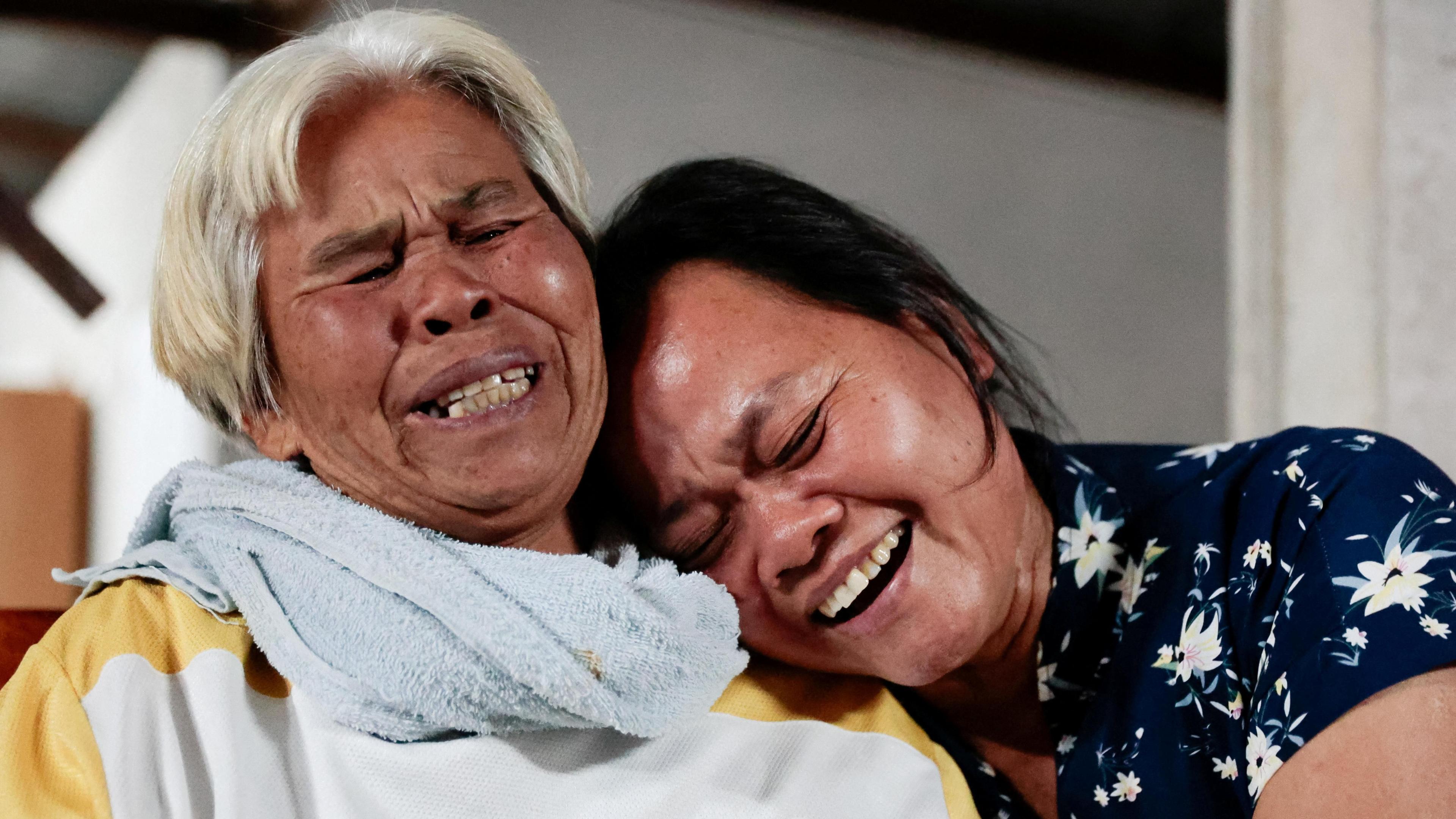 Wiwwaro Sriaoun, mother of released Thai hostage Watchara Sriaoun reacts with a relative, in Kut Yang village, Udon Thani province, Thailand (30 January 2025)