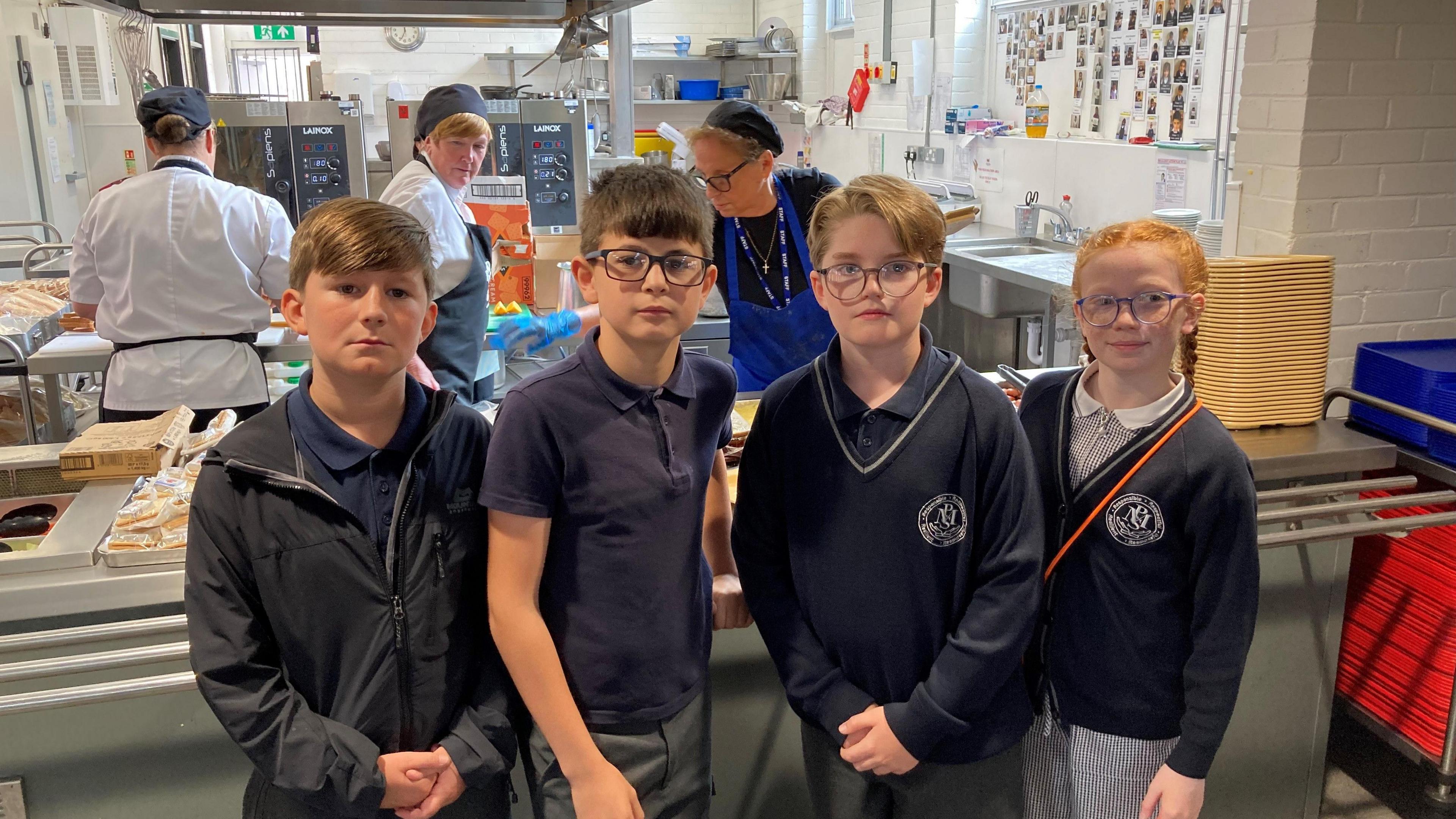 Max, Josie, Ahmed, Arthur. all aged 11, pose in the canteen of their school