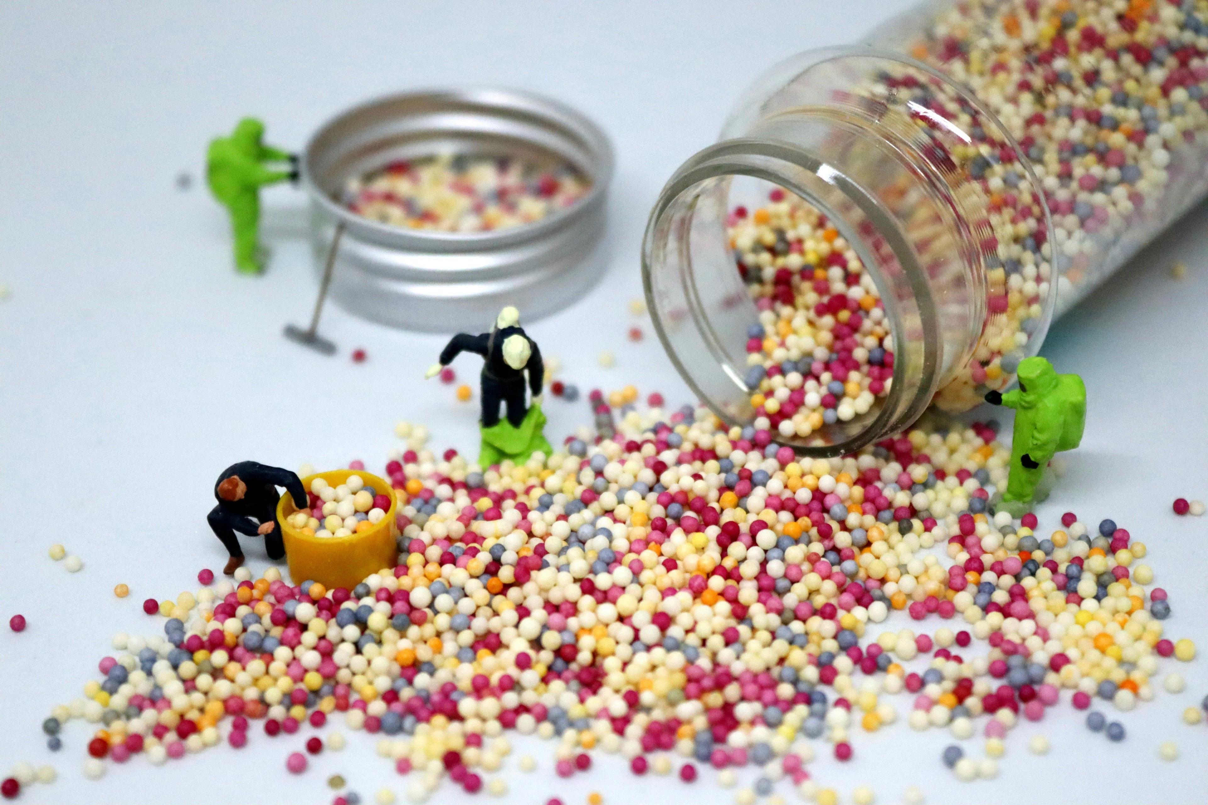 Model figures with a spilt jar of hundreds and thousands cake topping