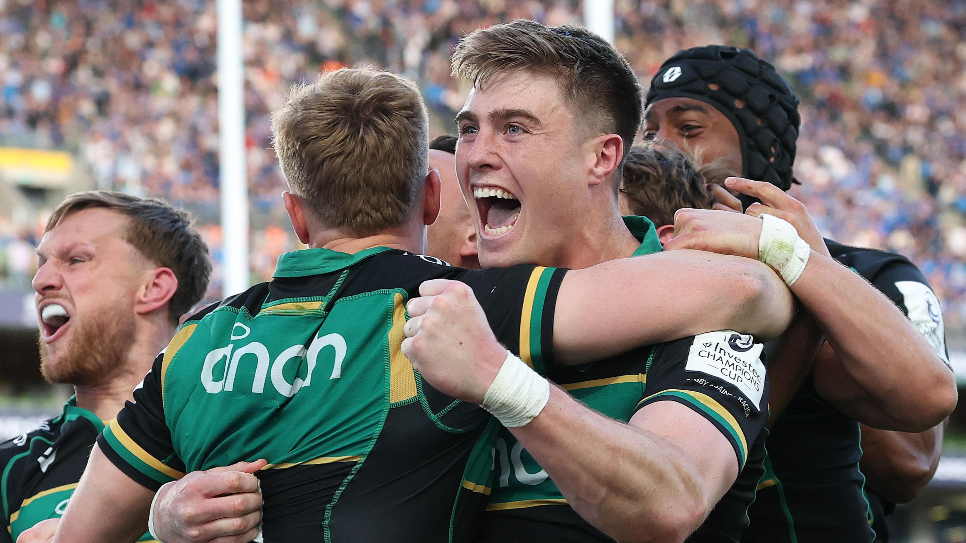 Tommy Freeman, of Northampton Saints, celebrates with a group of his teammates at the Aviva Stadium in Dublin.