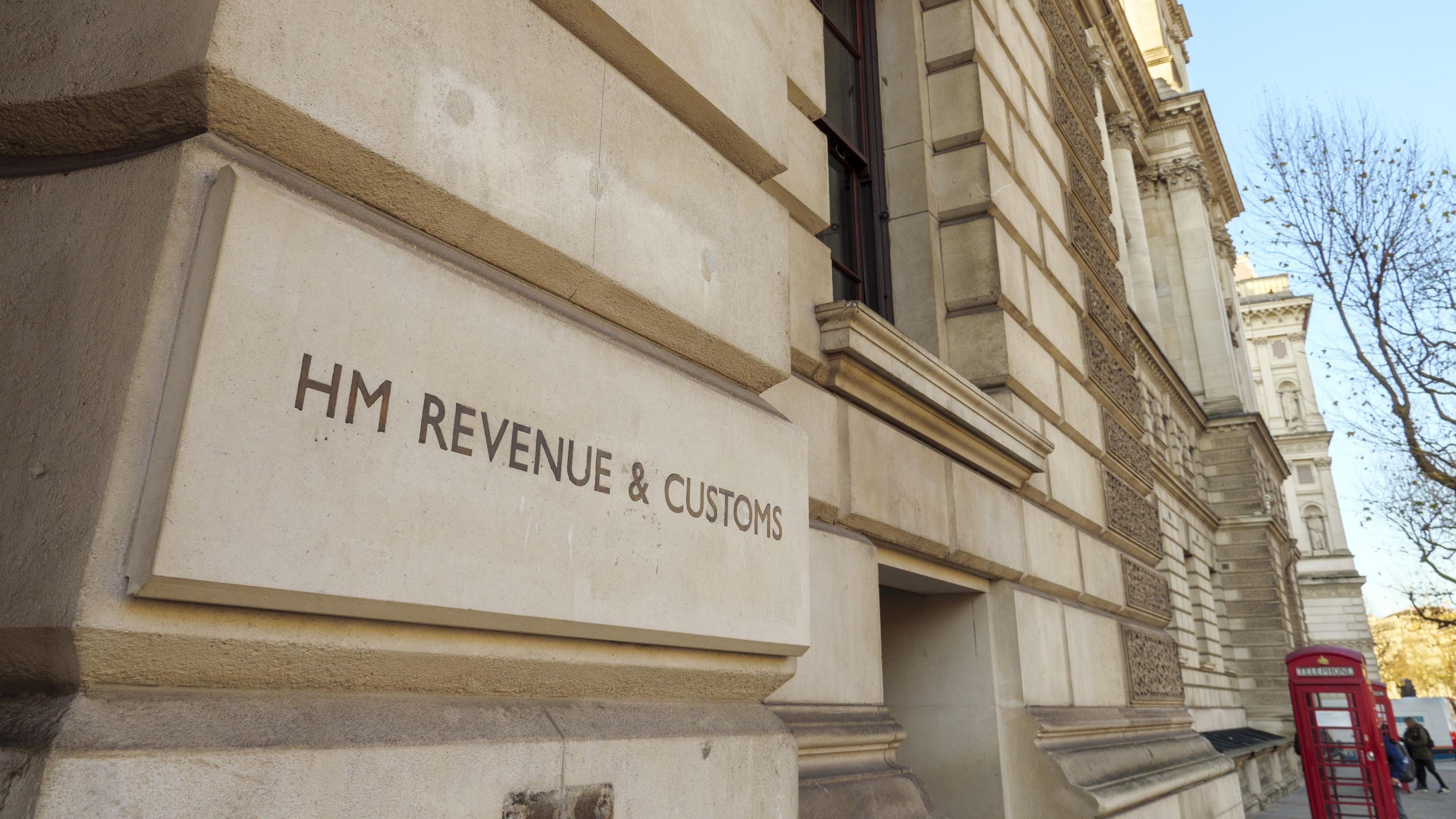 The HMRC building in Whitehall, London, showing the white Portland stone side and a close up of the HM Revenue and Customs sign