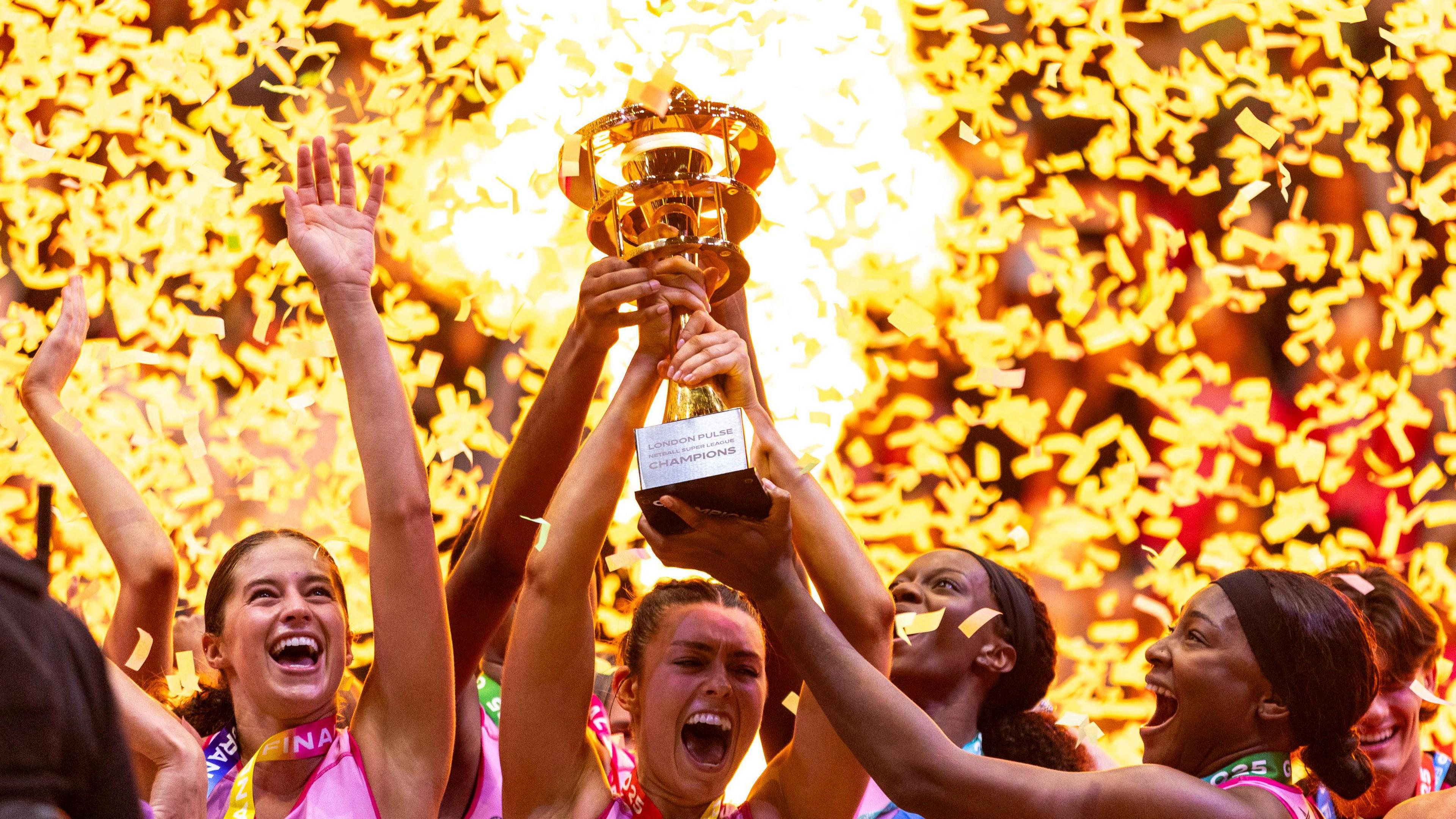 London Pulse players celebrate with the trophy after winning the Netball Super League Grand Final at the O2 Arena, London.