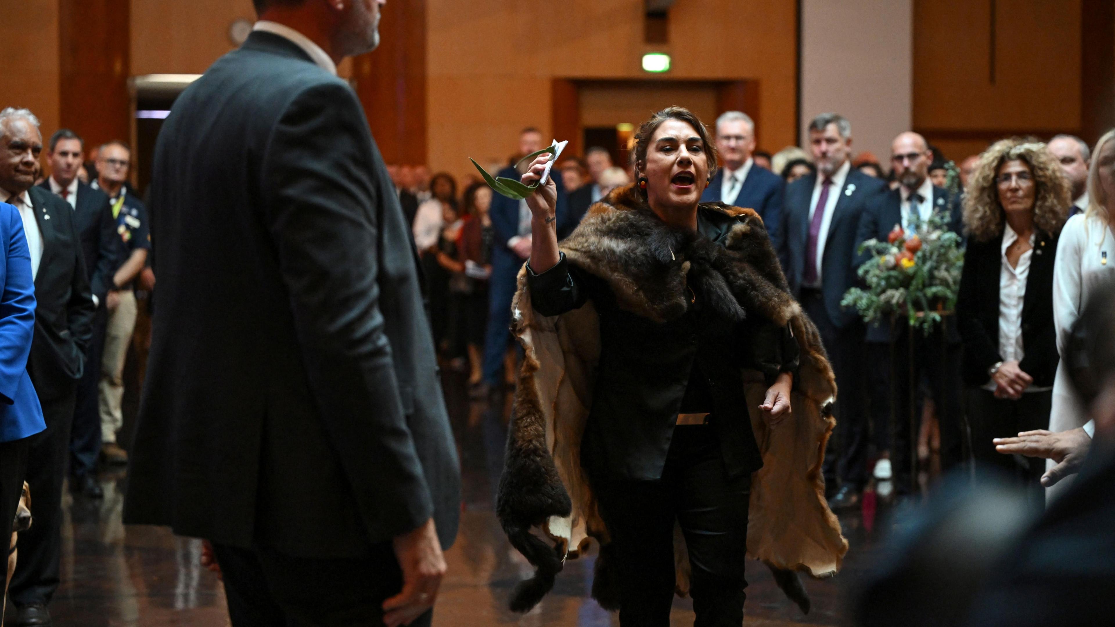 Australian Senator Lidia Thorpe disrupts proceedings, shouting a protest in front of a large crowd.