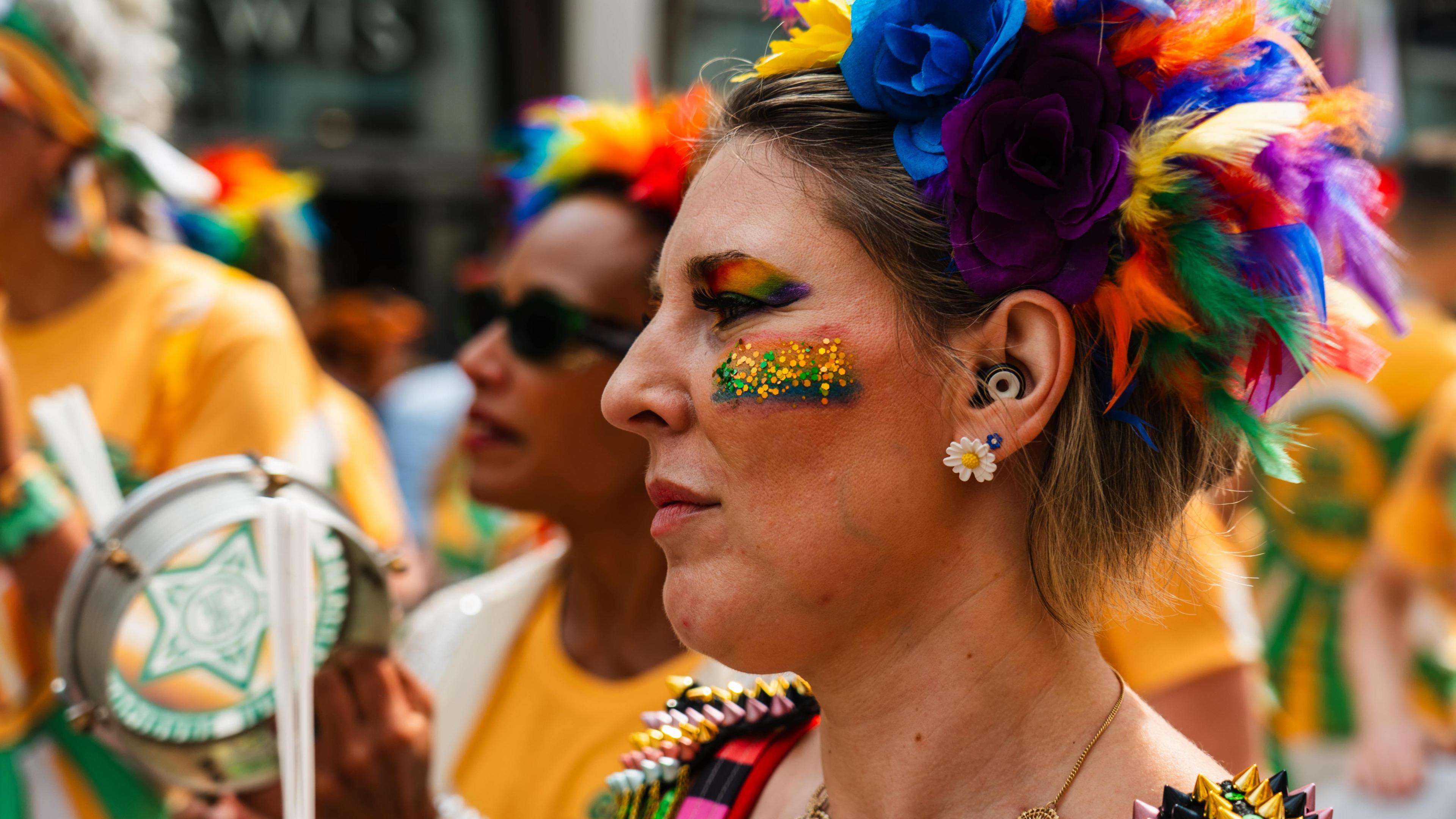 A person wearing a rainbow head dress 