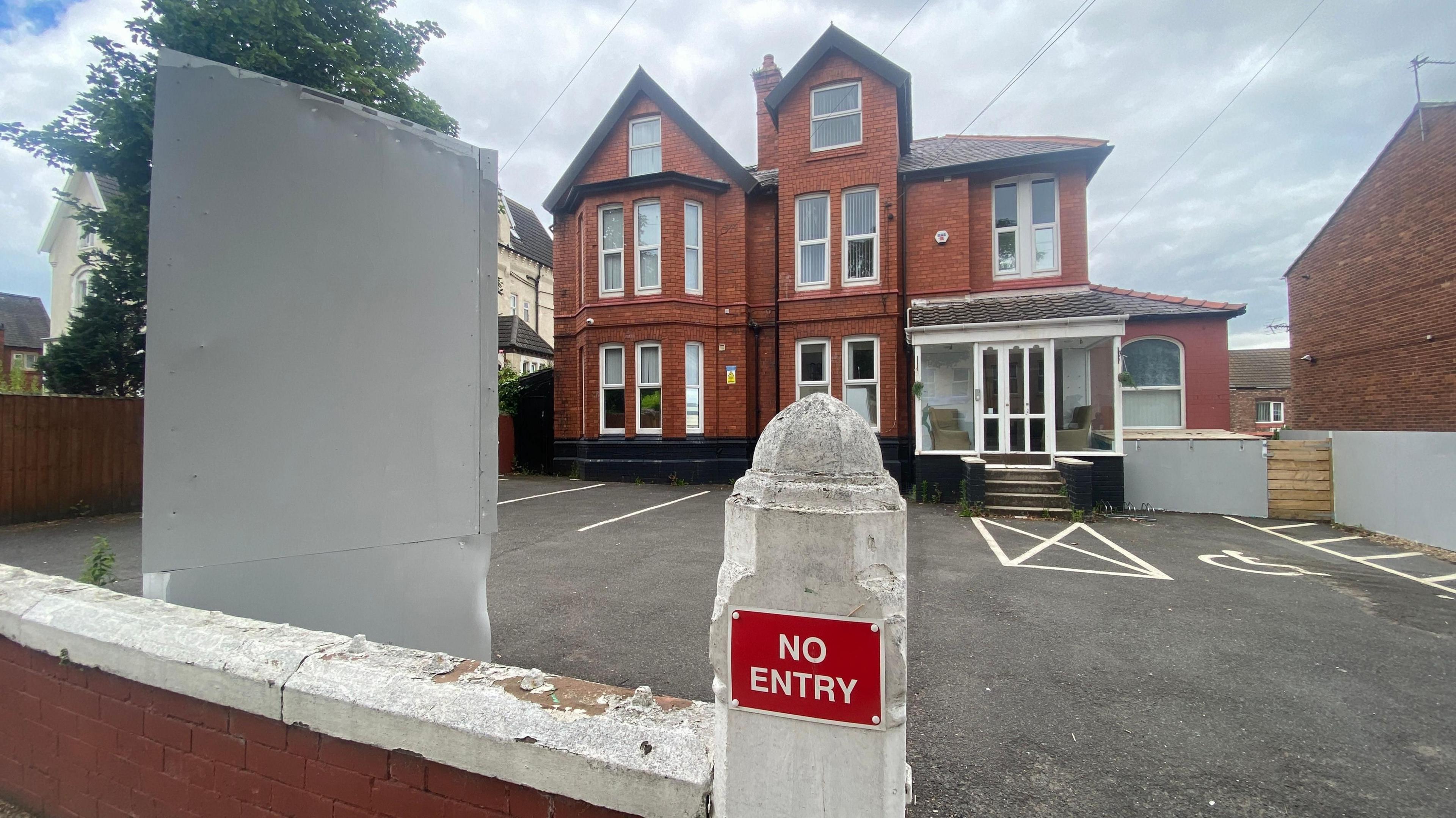 Life Wirral - a victorian style building set at the back of a forecourt- a post on the wall at the entrance reads No Entry