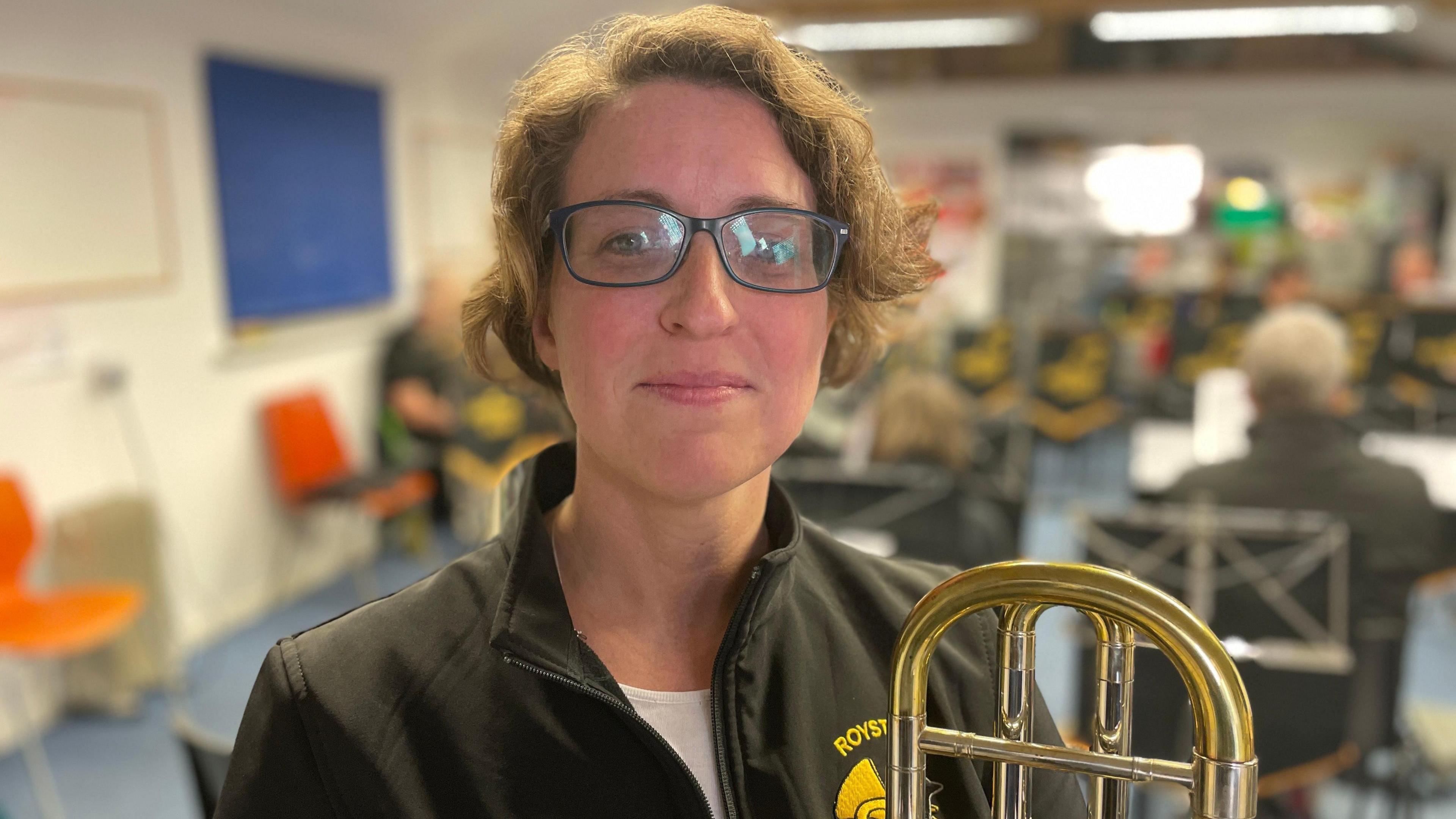 Charmian Flowerday holding a brass instrument