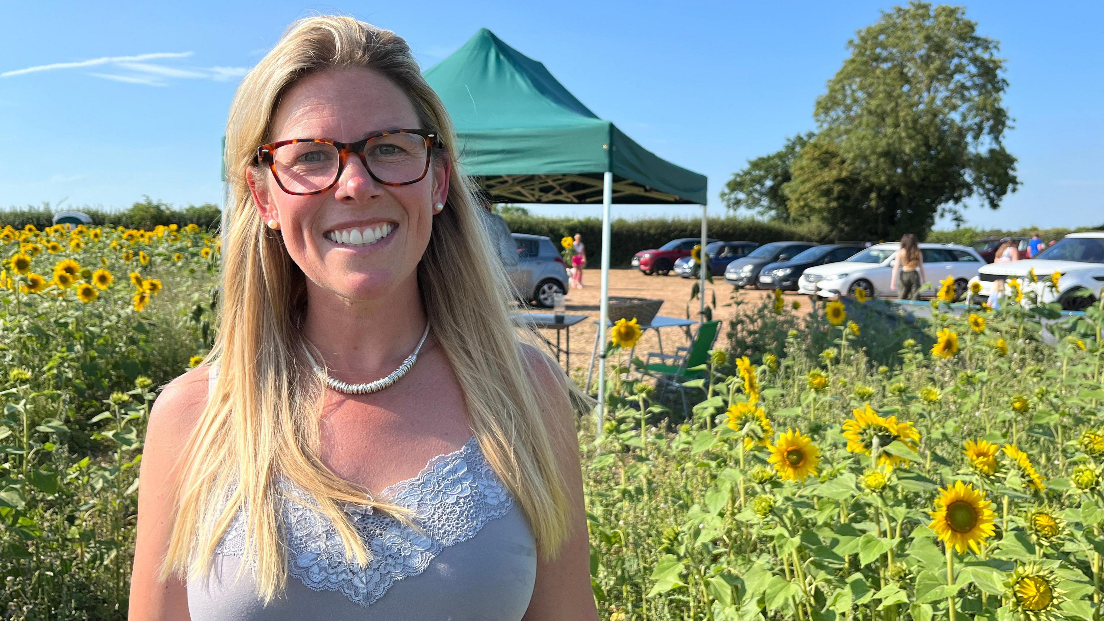 Claire pictured in front of the sunflowers