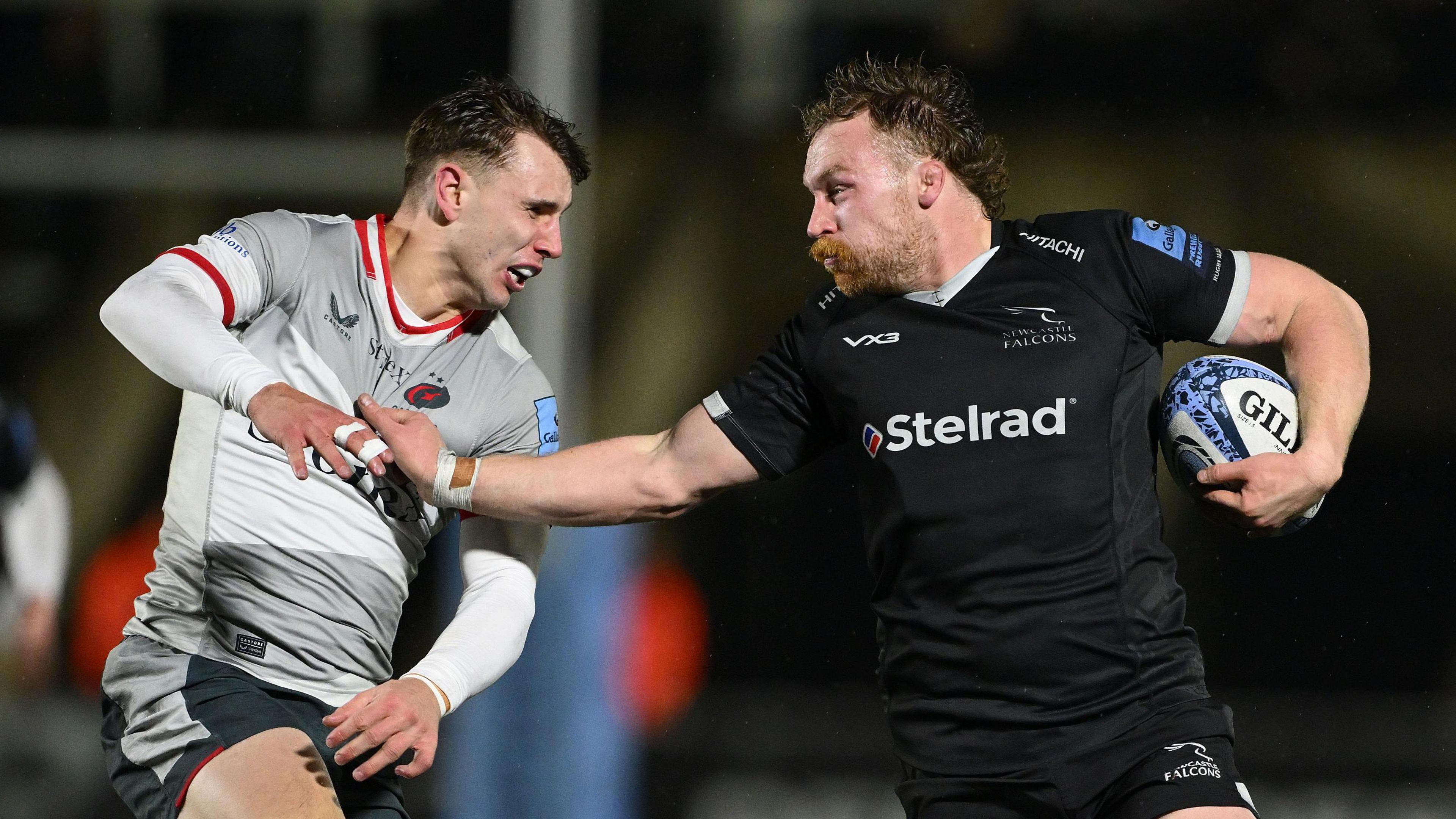 Newcastle Falcons player Tom Gordon holds off Tobias Elliott of Saracens