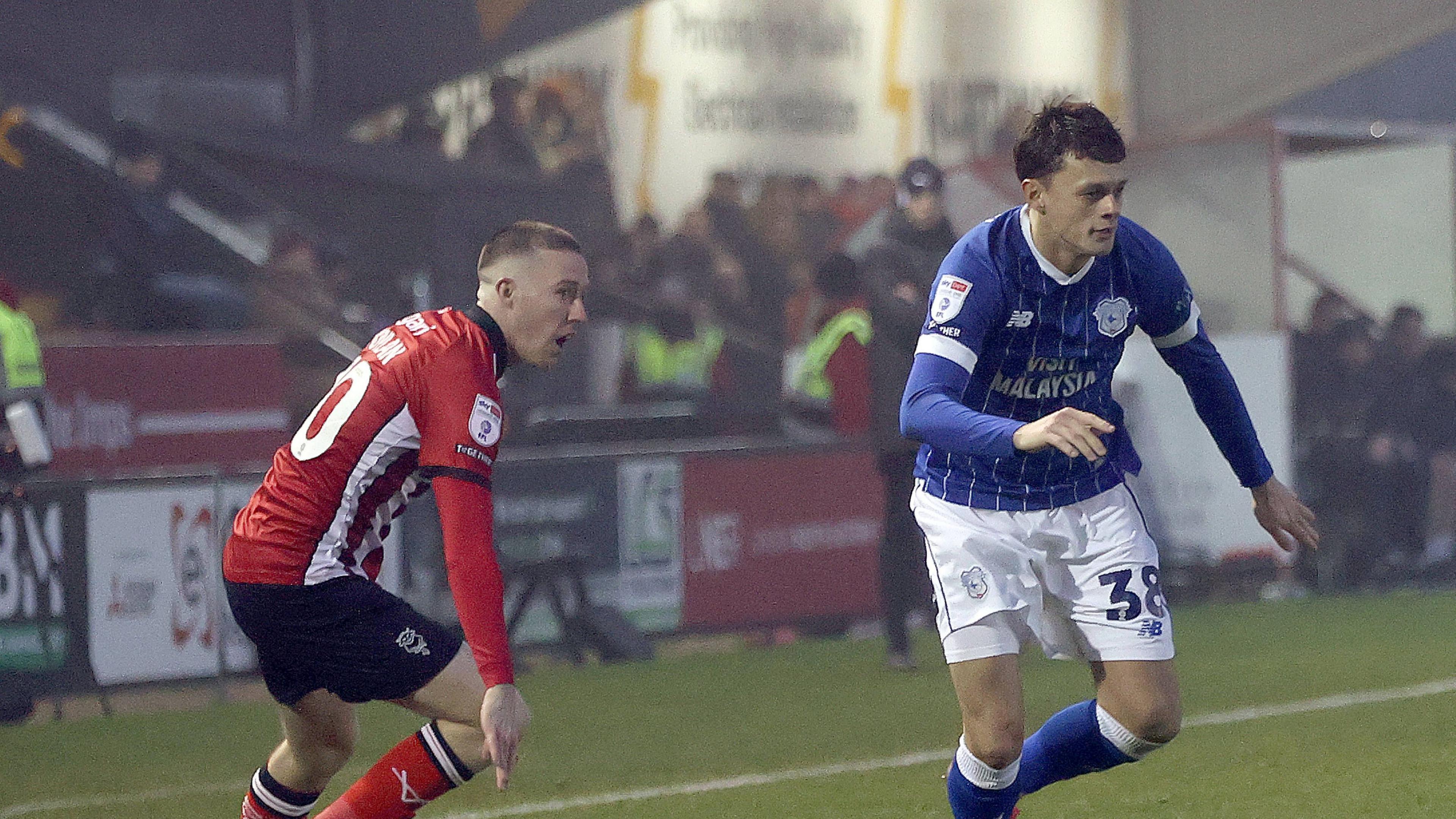 Cardiff City players Perry NG and Jack Moylan battling against each other last season as Cardiff played Lincoln at Sincil Bank