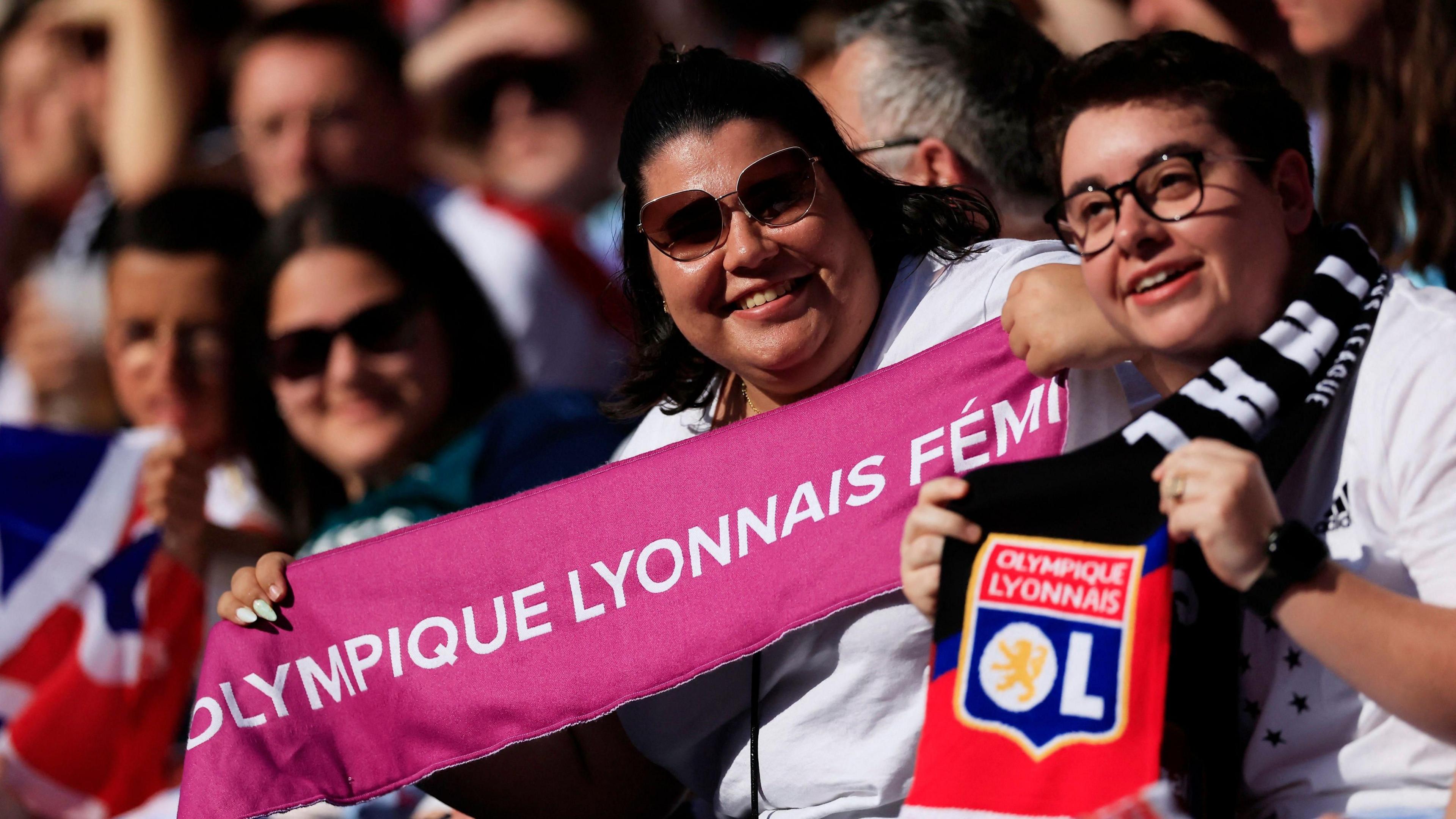Lyon fans hold up a scarf in the stadium