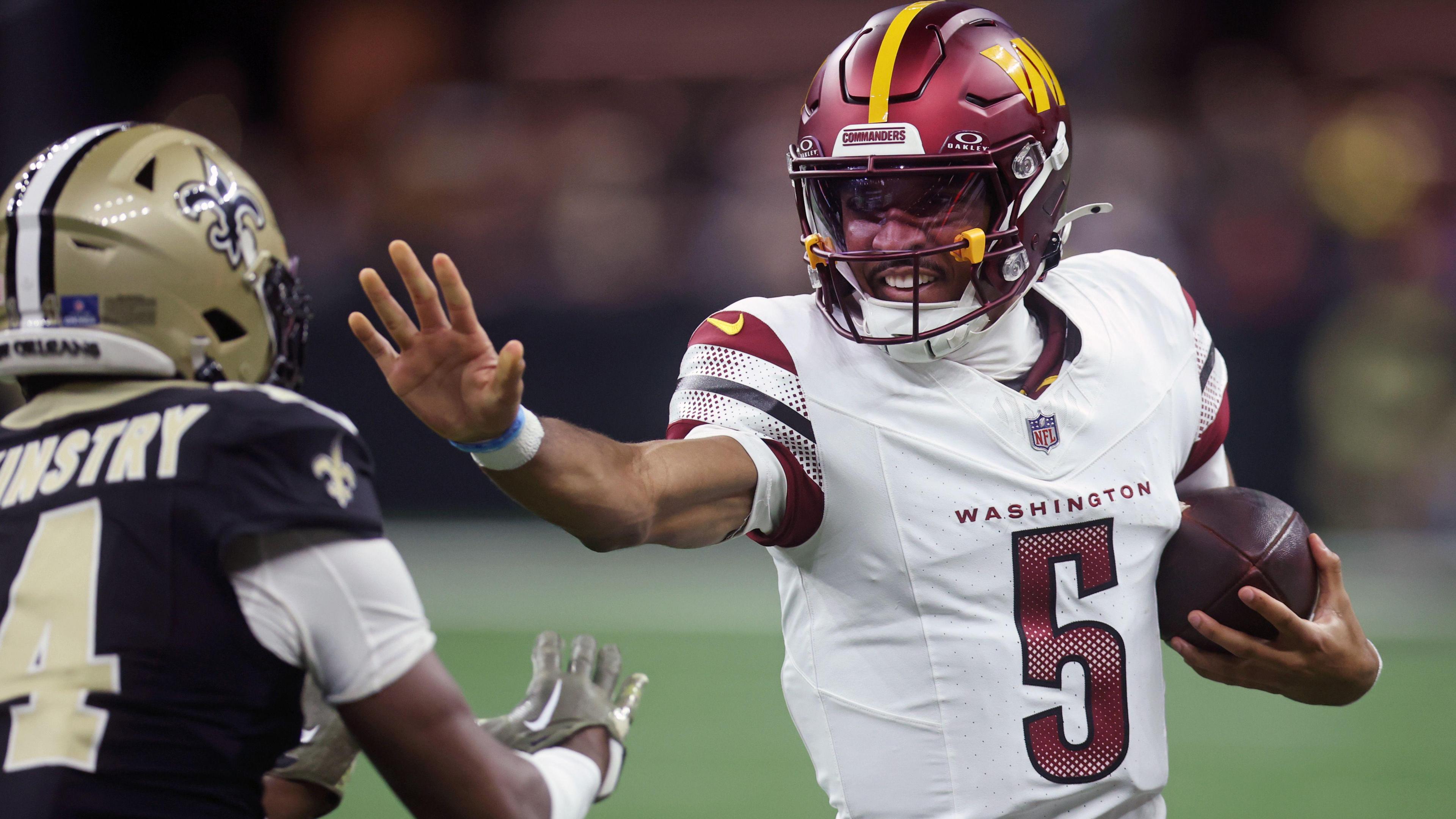 Washington Commanders quarterback Jayden Daniels running with the ball against the New Orleans Saints