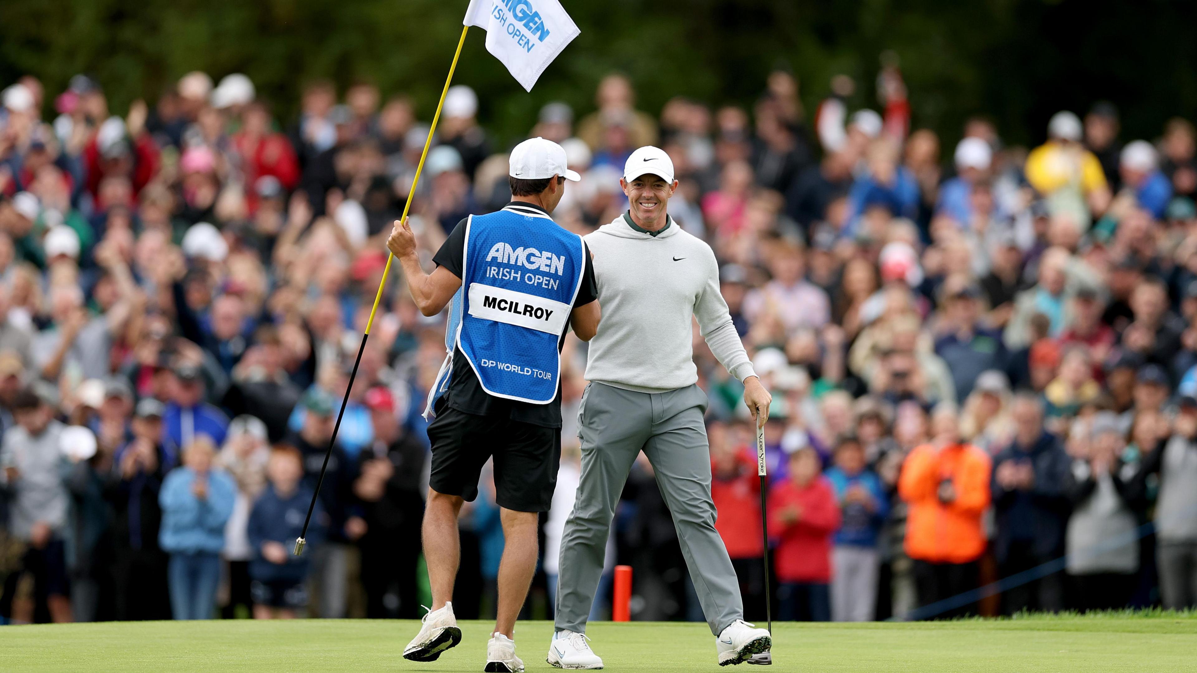 Rory McIlroy celebrates holing an eagle putt on the final hole of the Irish Open with his caddie Harry Diamond