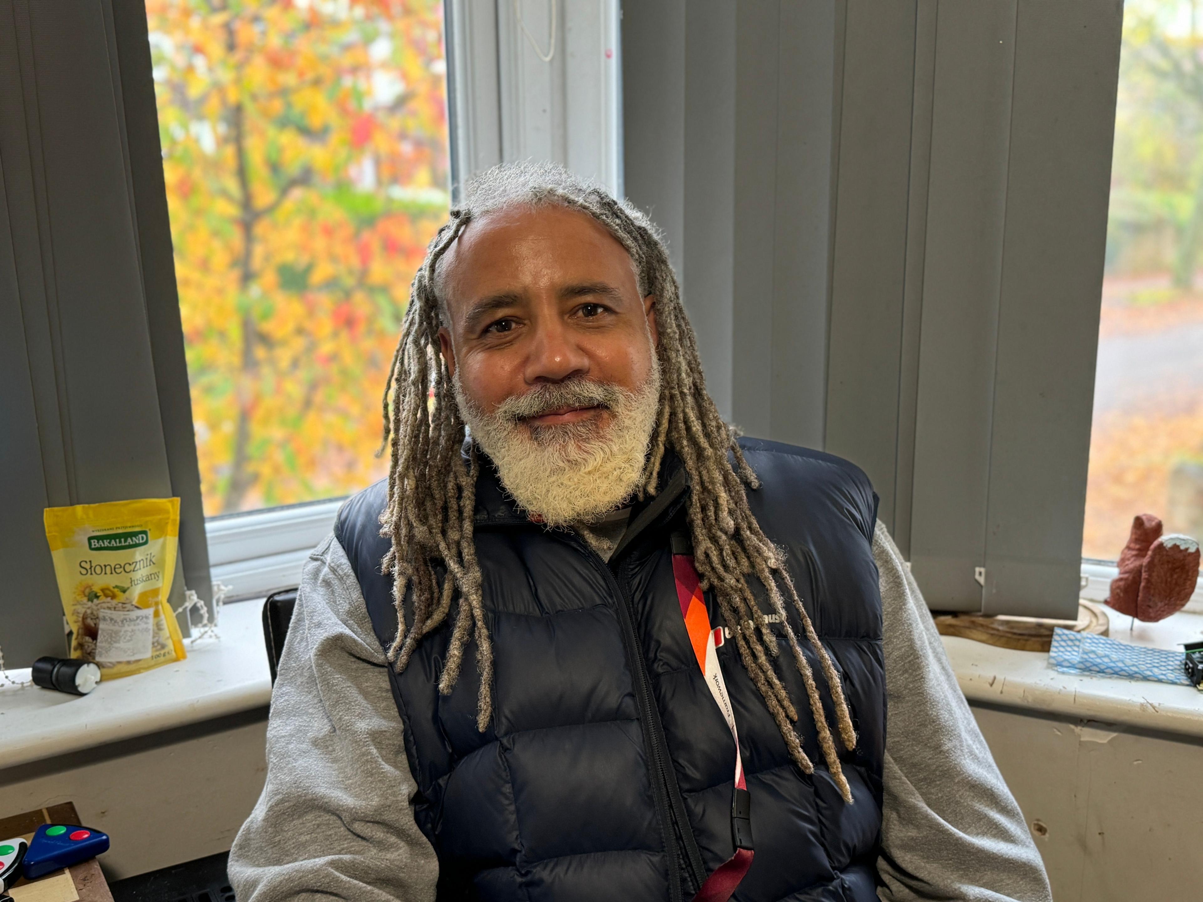 A man sat in front of a window in a flat in Nottingham. 