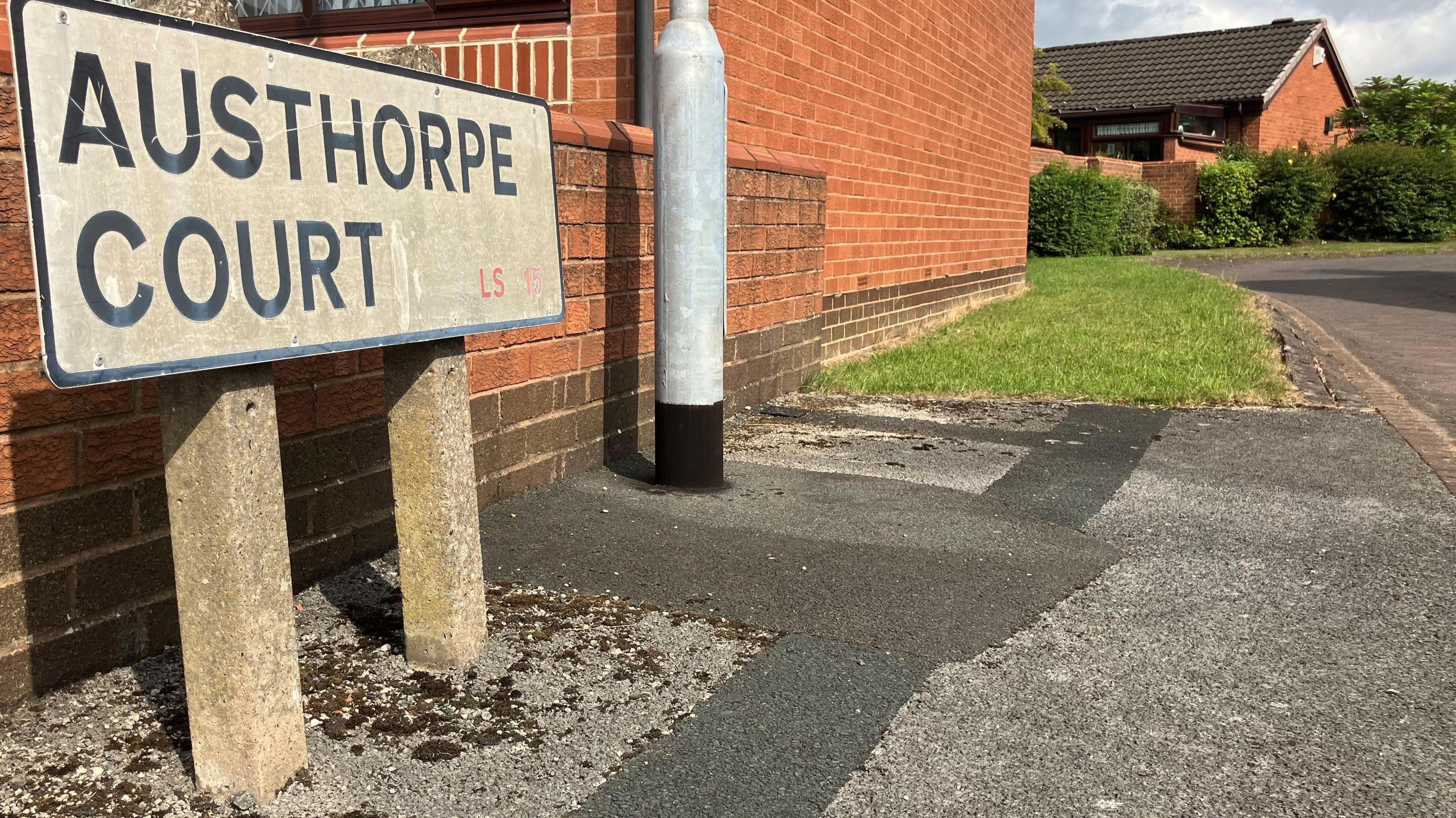 A street sign for Austhorpe Court.