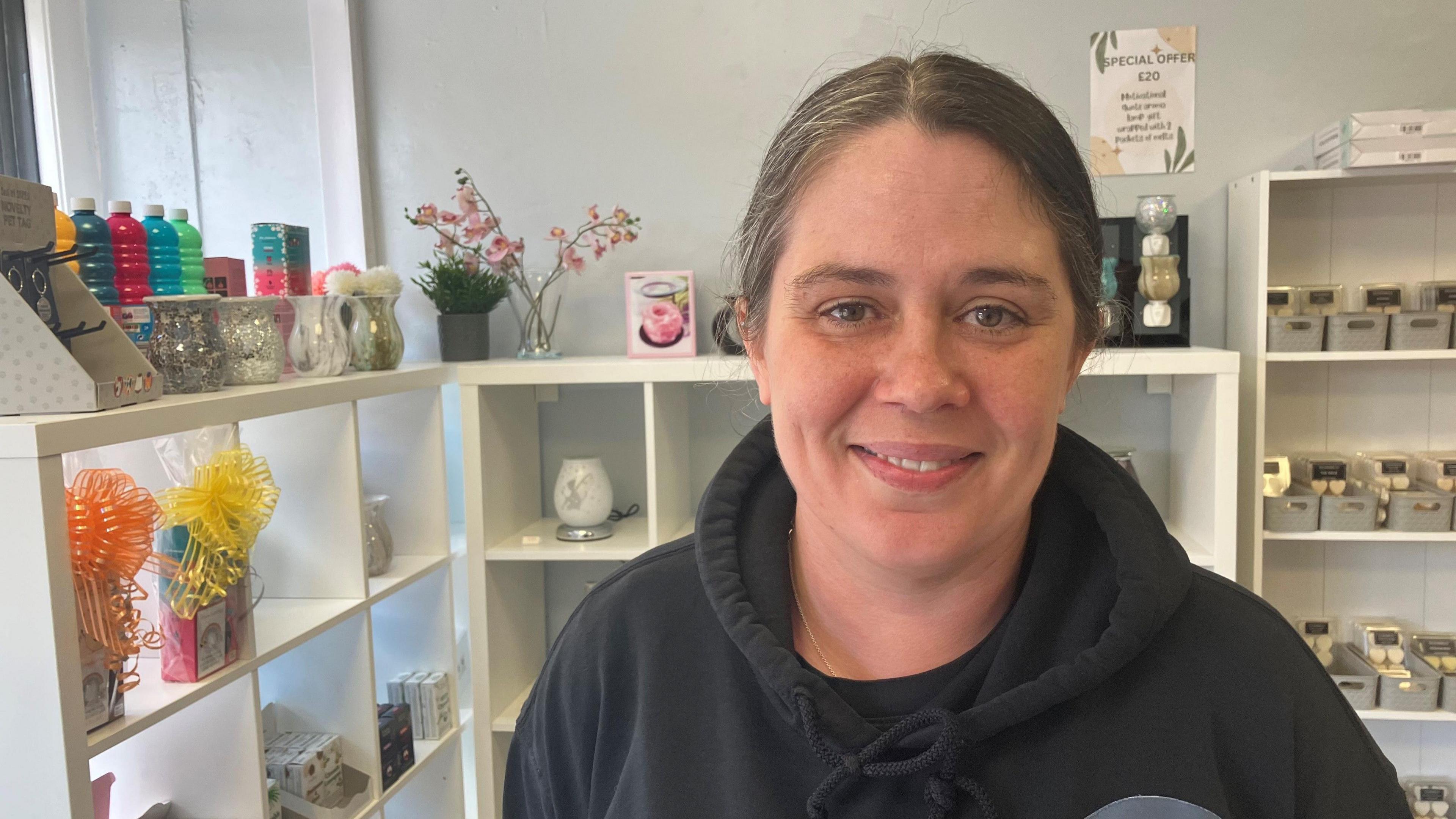 Photograph of shopkeeper inside her store in the Castleton area of Rochdale