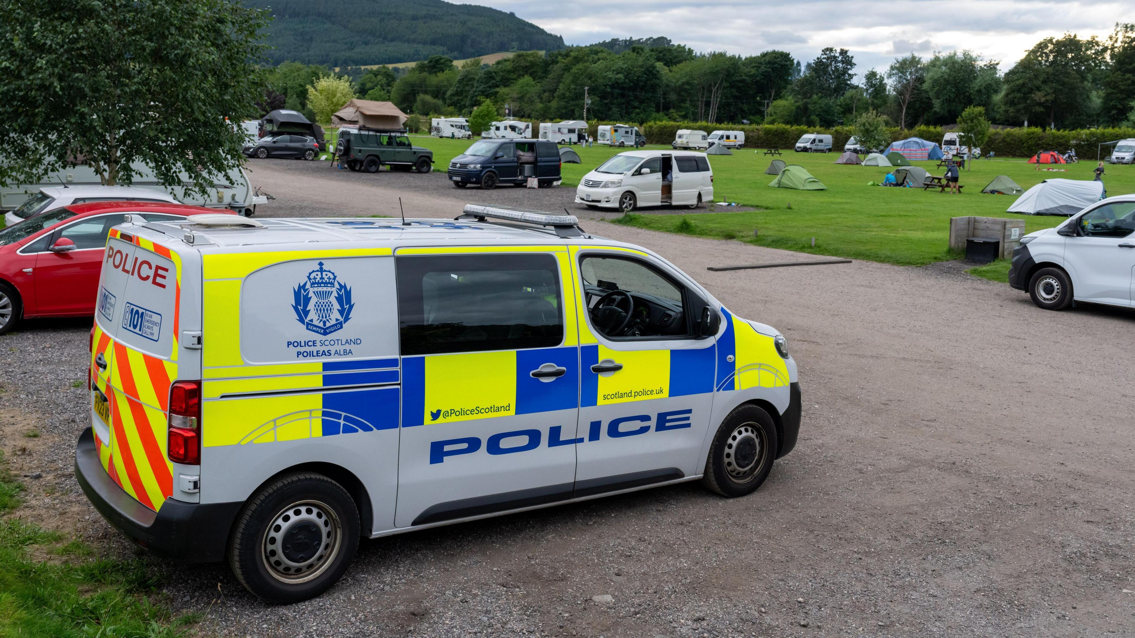 Police van in the camp site