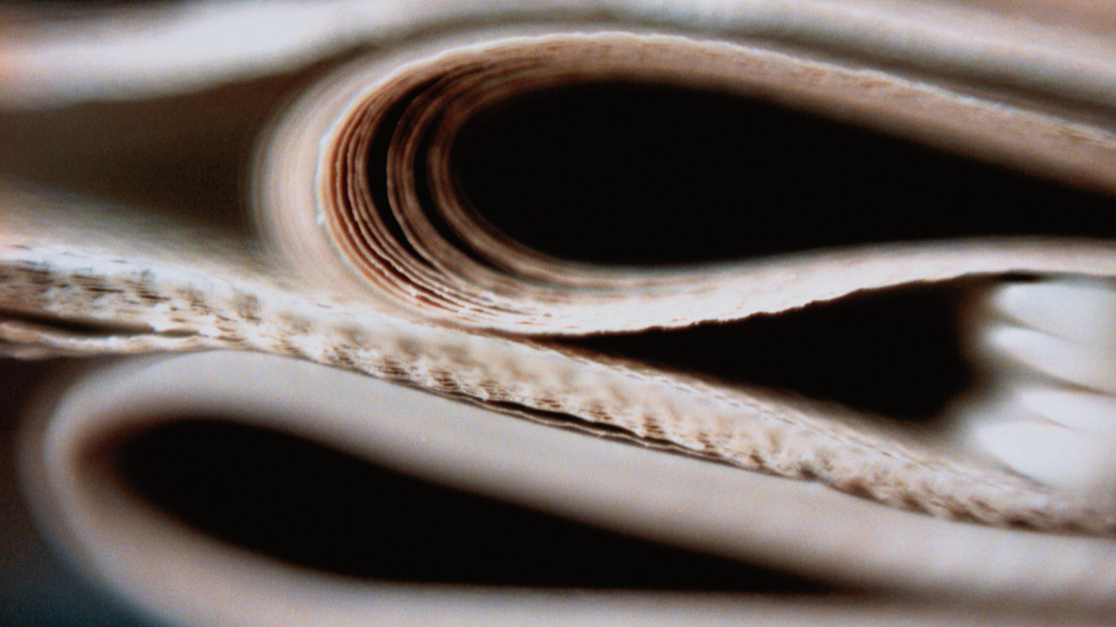 A close up of a pile of folded newspapers.