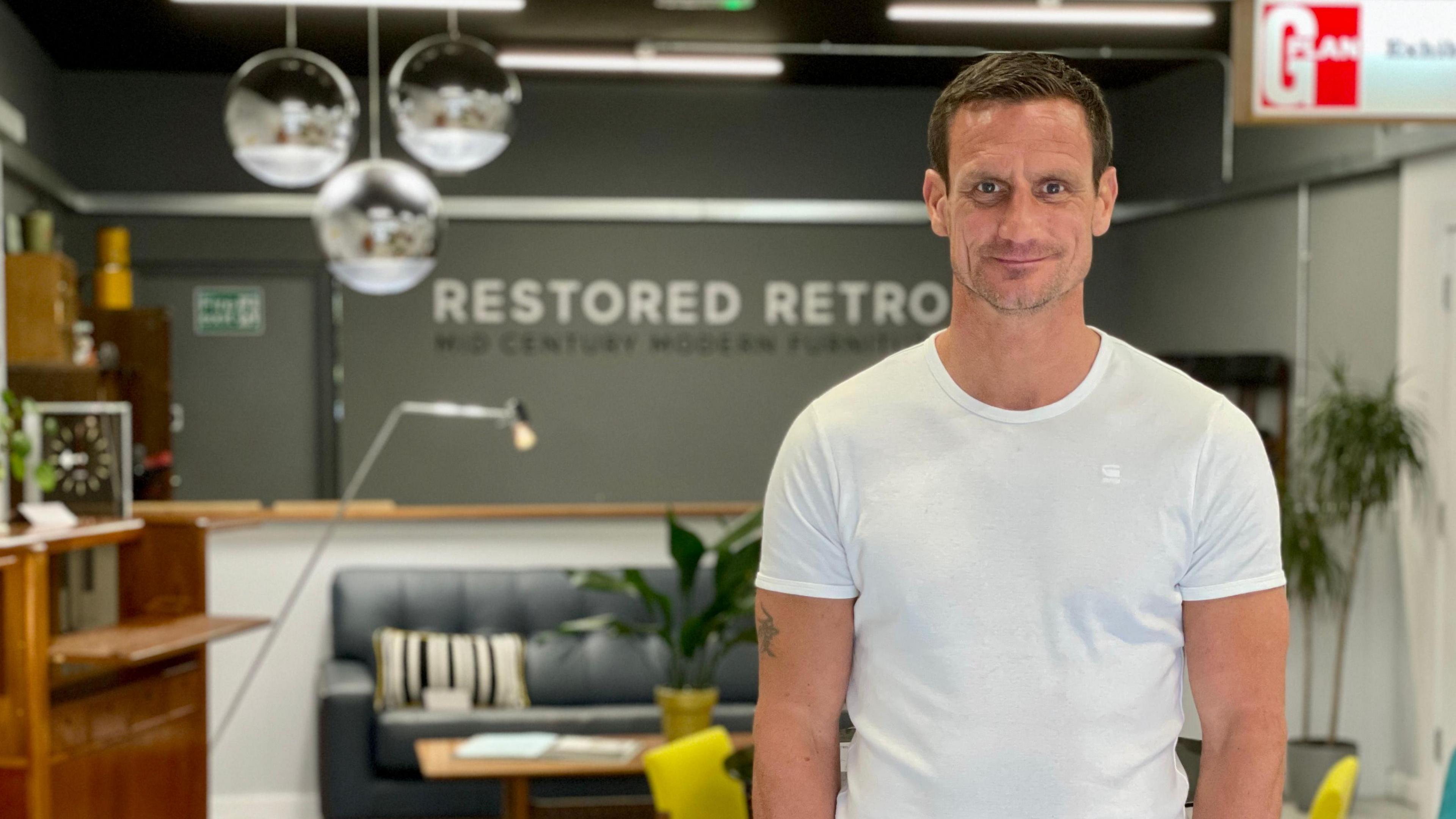 Steve Wyatt inside his shop with furniture for sale in the background