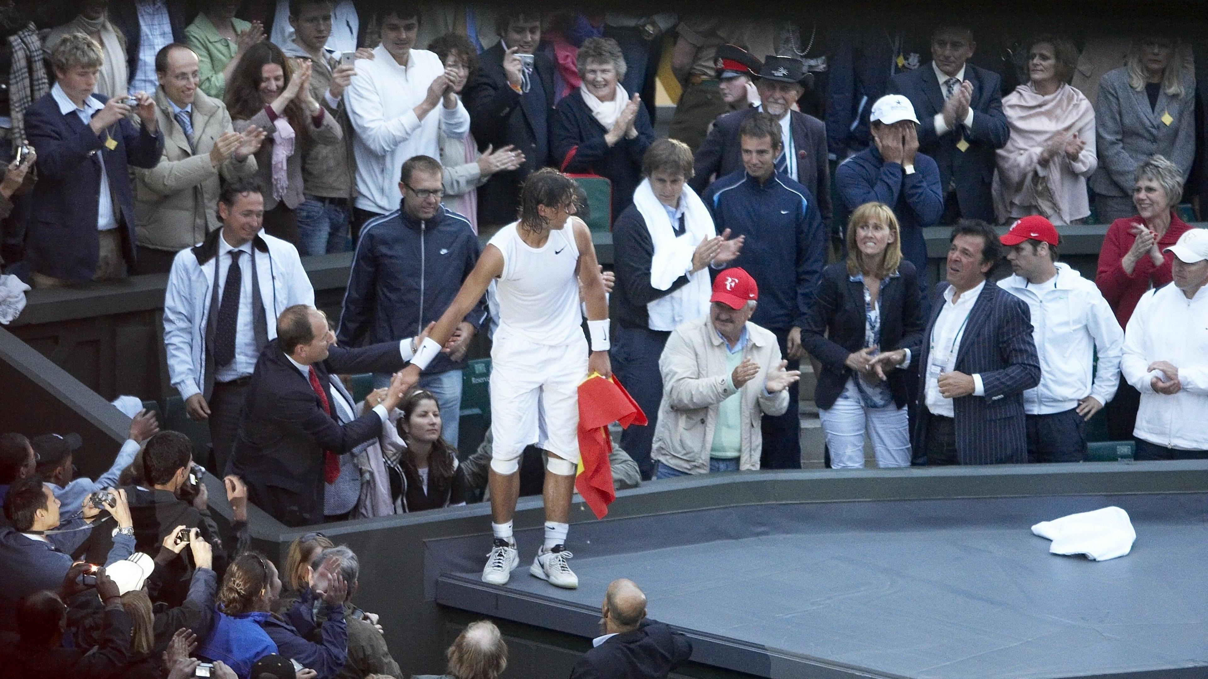 Rafael Nadal climbs into the stands on Centre Court after winning Wimbledon in 2008