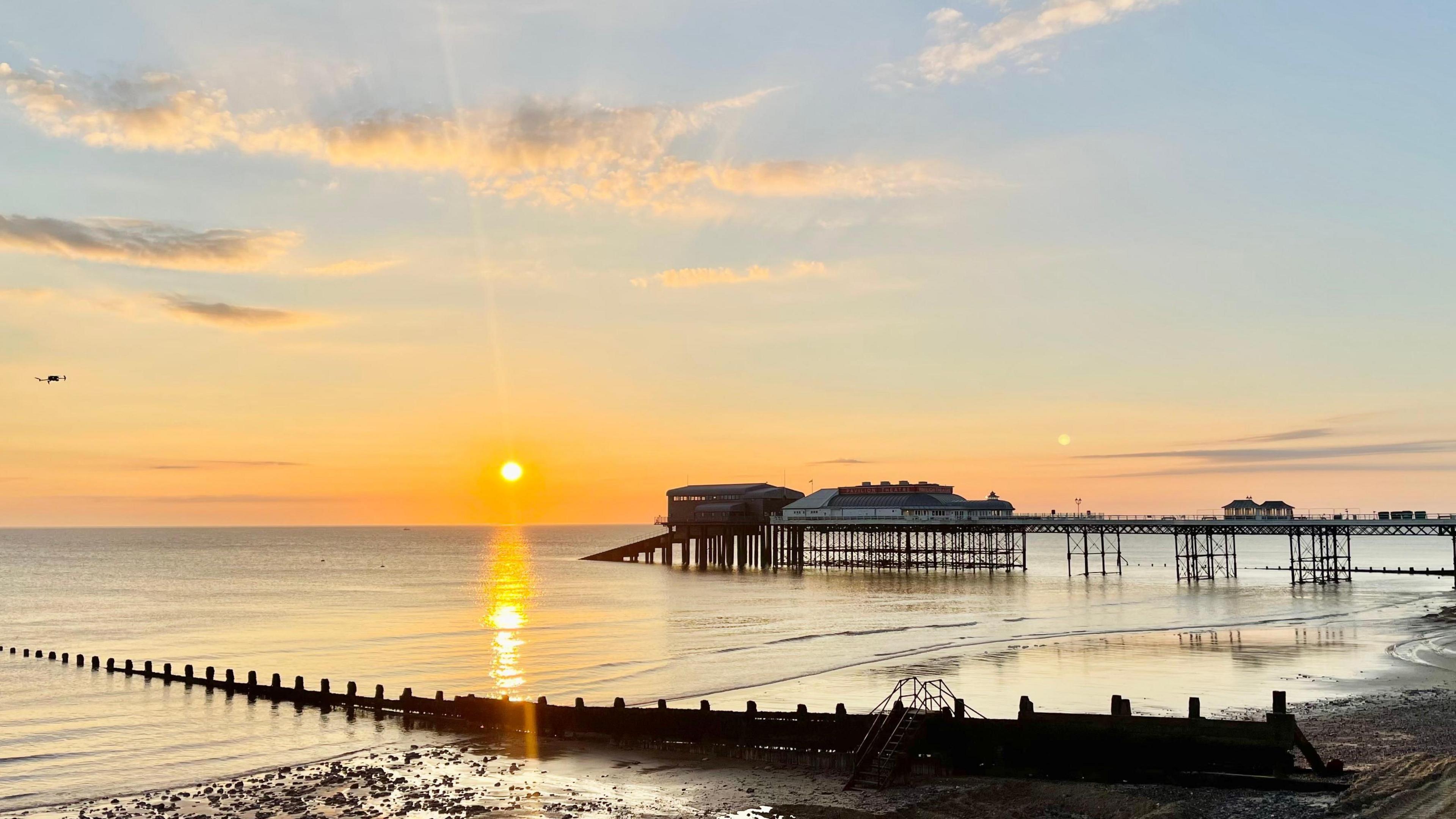 Sun rising over Cromer beach in Norfolk