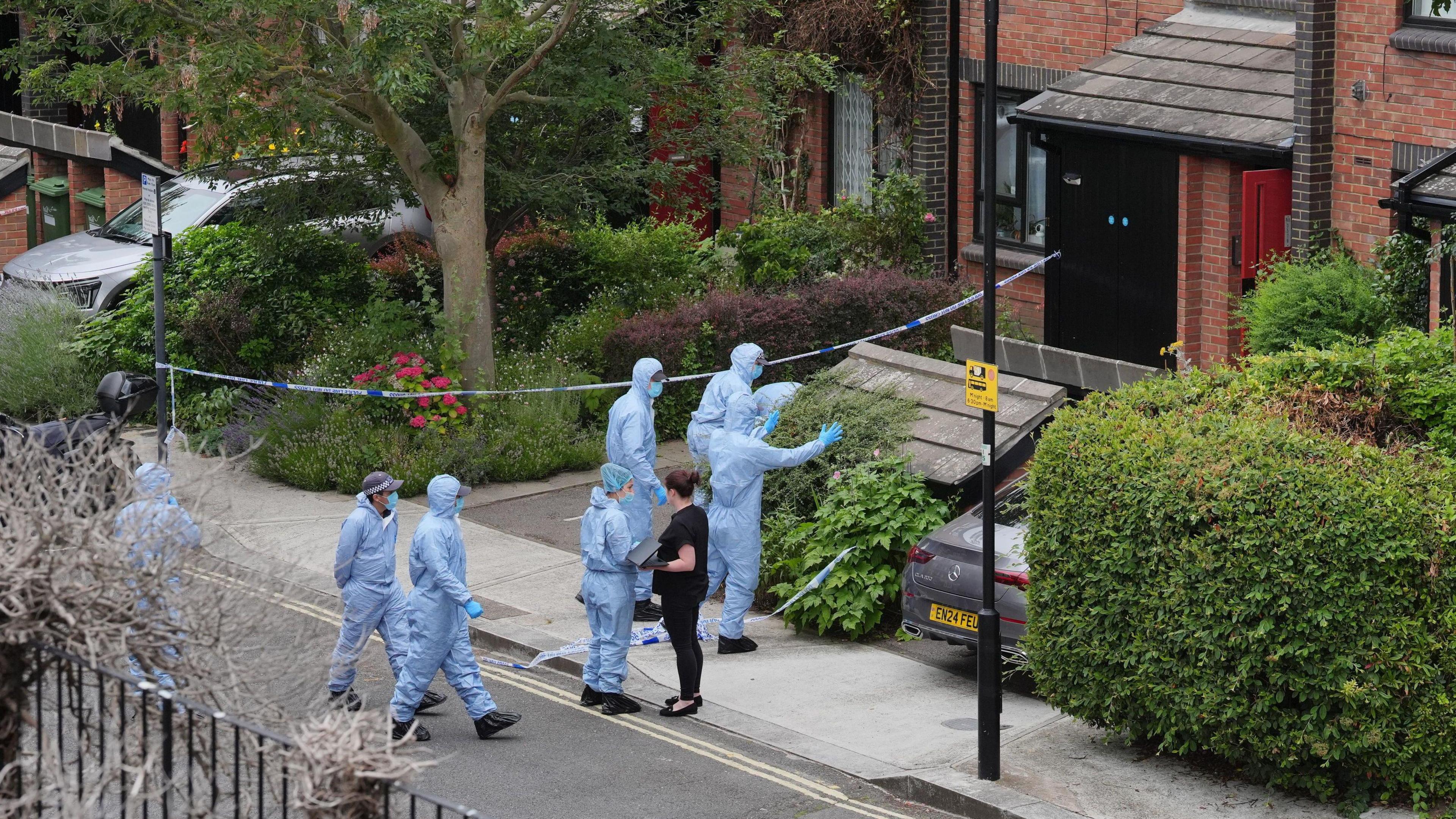 Forensic officers outside house on Scott's Road