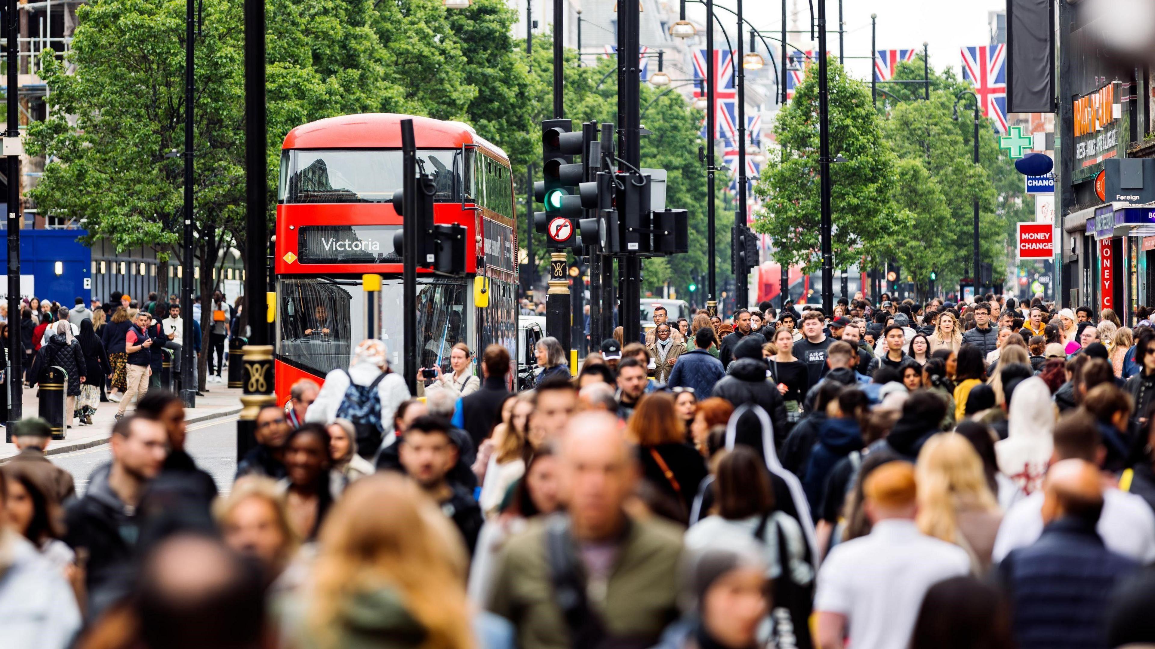 File image showing a busy street scene on Oxford Street, with lots of pedestrians and buses