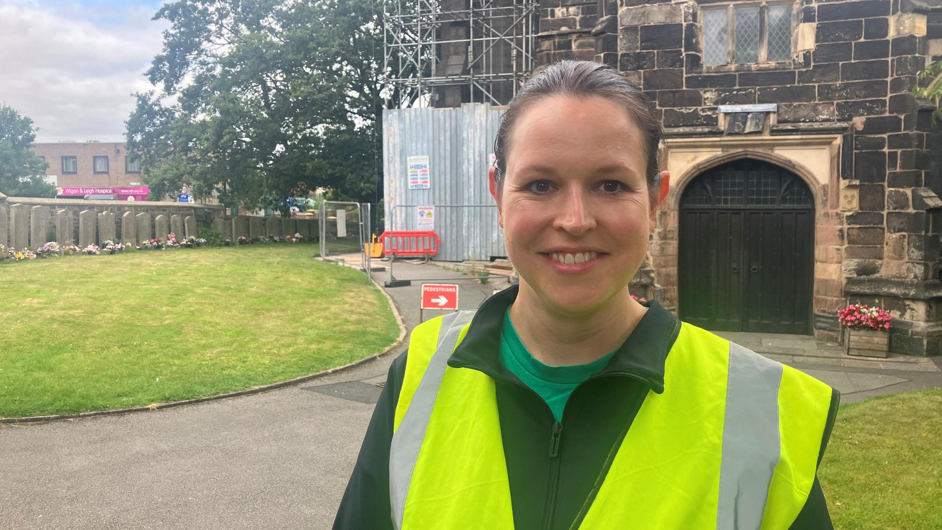 Photograph of the architect Becky Gilbert-Rule. She is pictured in the church yard of St Wilfrid's in Standish.