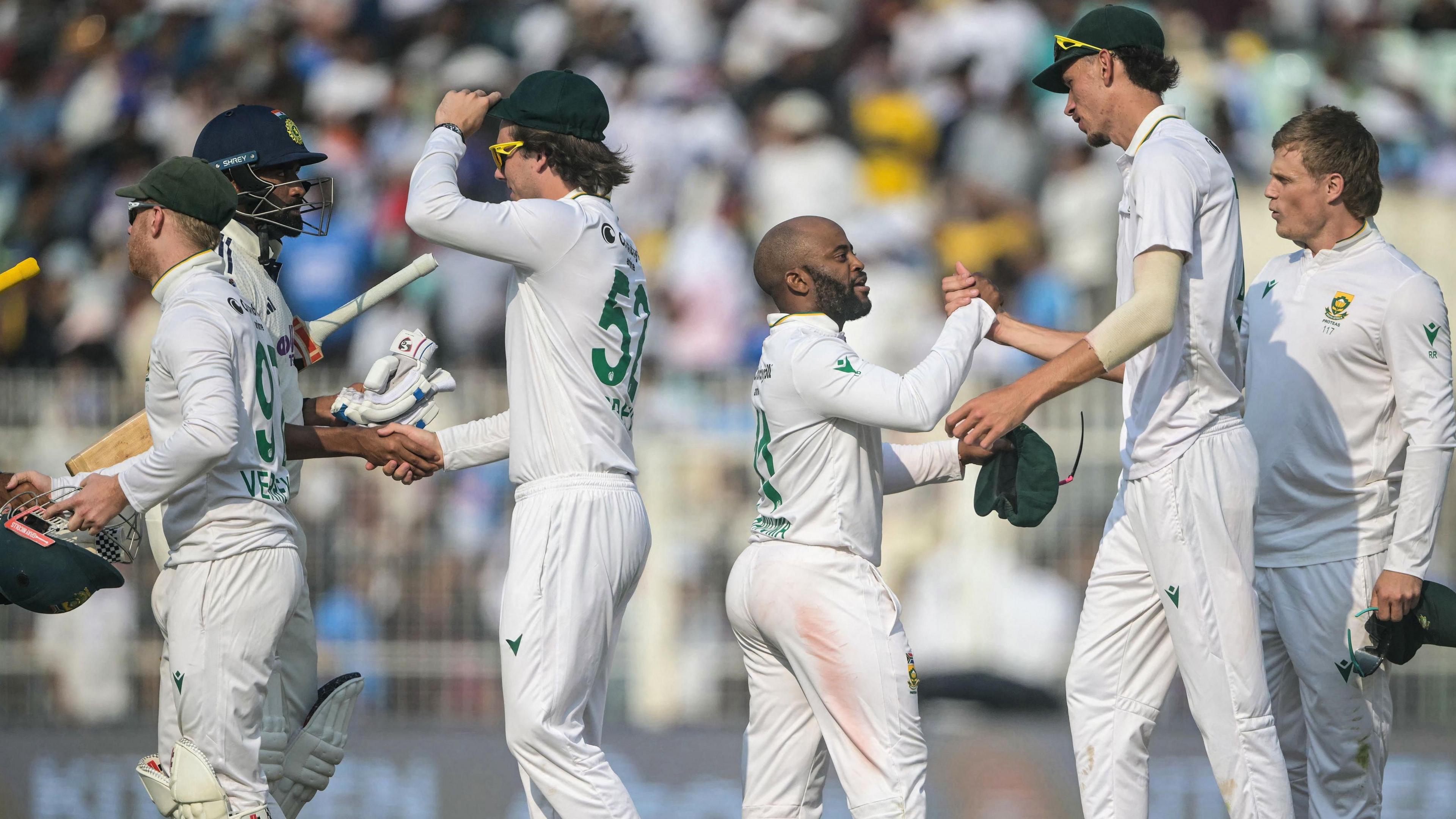 India and South Africa players shake hands after the first Test